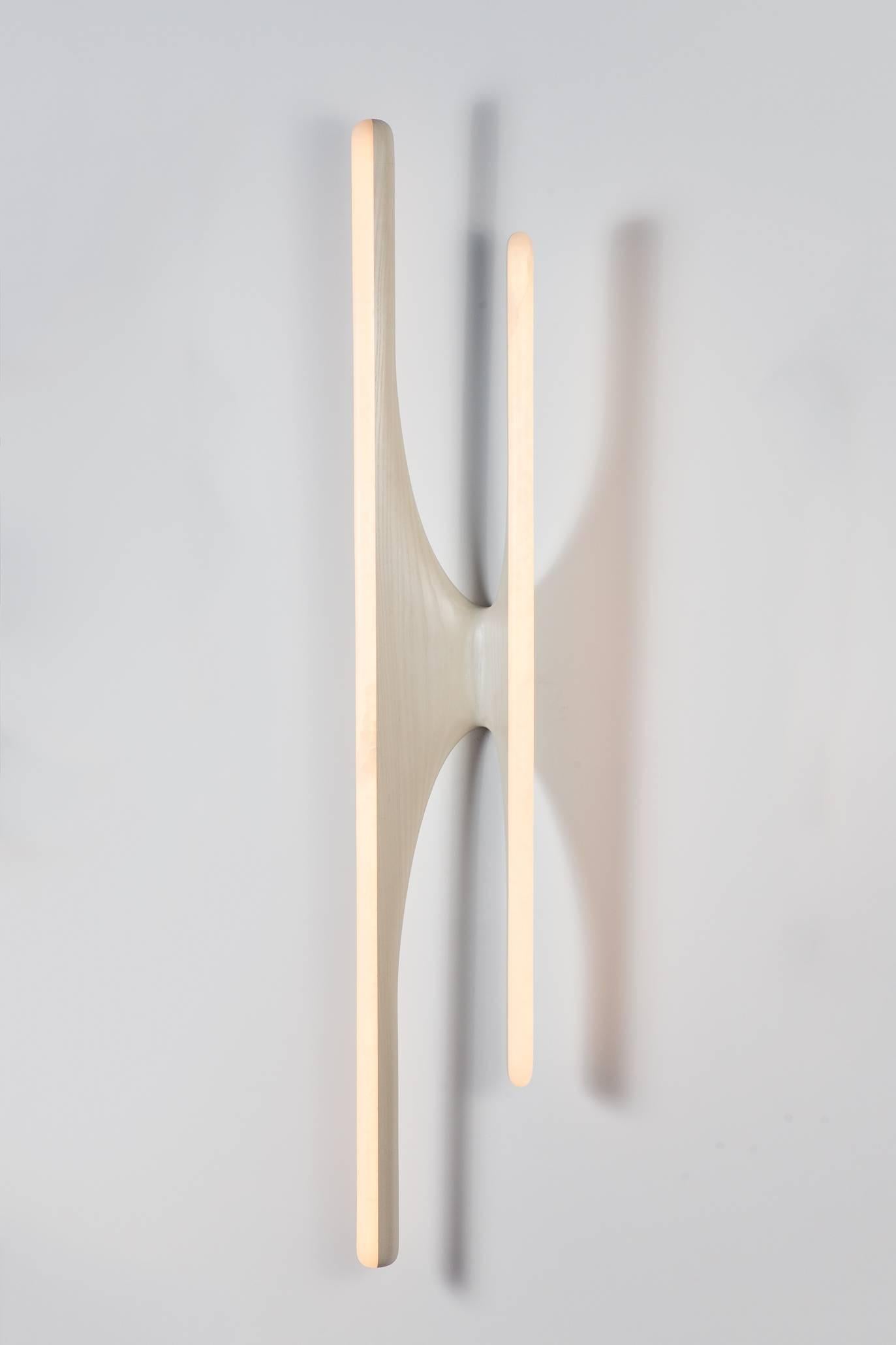 Markus Haase’s unique, hand-sculpted onyx and bleached ash sconce retains a luminescent quality, even when unlit. Its luster and smooth finish renders the piece to appear sealed in its raw state. Powered by the most advanced LED technology, the