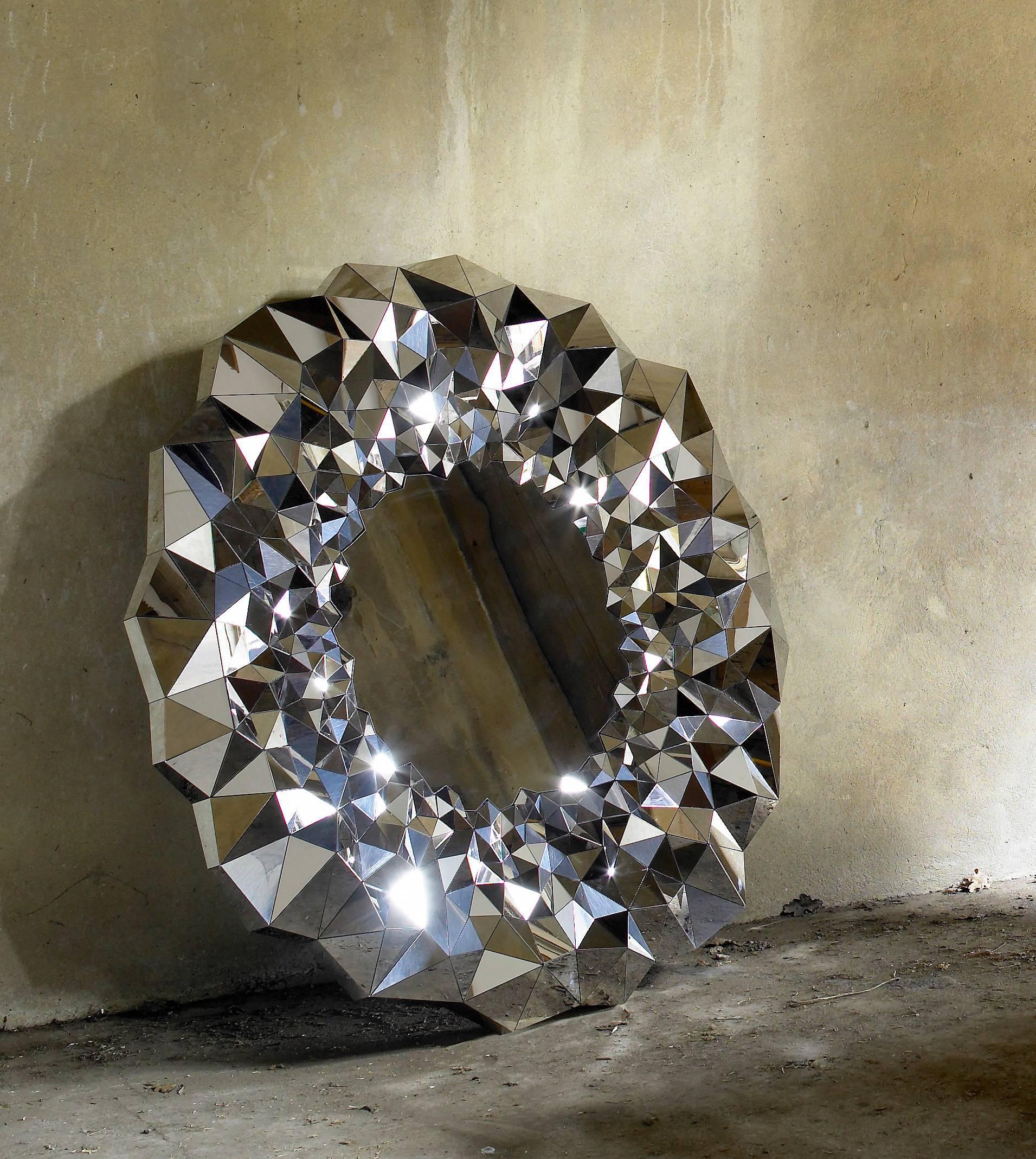 Inspired by the precious qualities of naturally forming amethyst geodes and machine cut diamonds, Jake Phipp’s Stellar mirror is a unique work of art made of super mirror stainless steel. The large expansive surfaces on the mirror are in stark