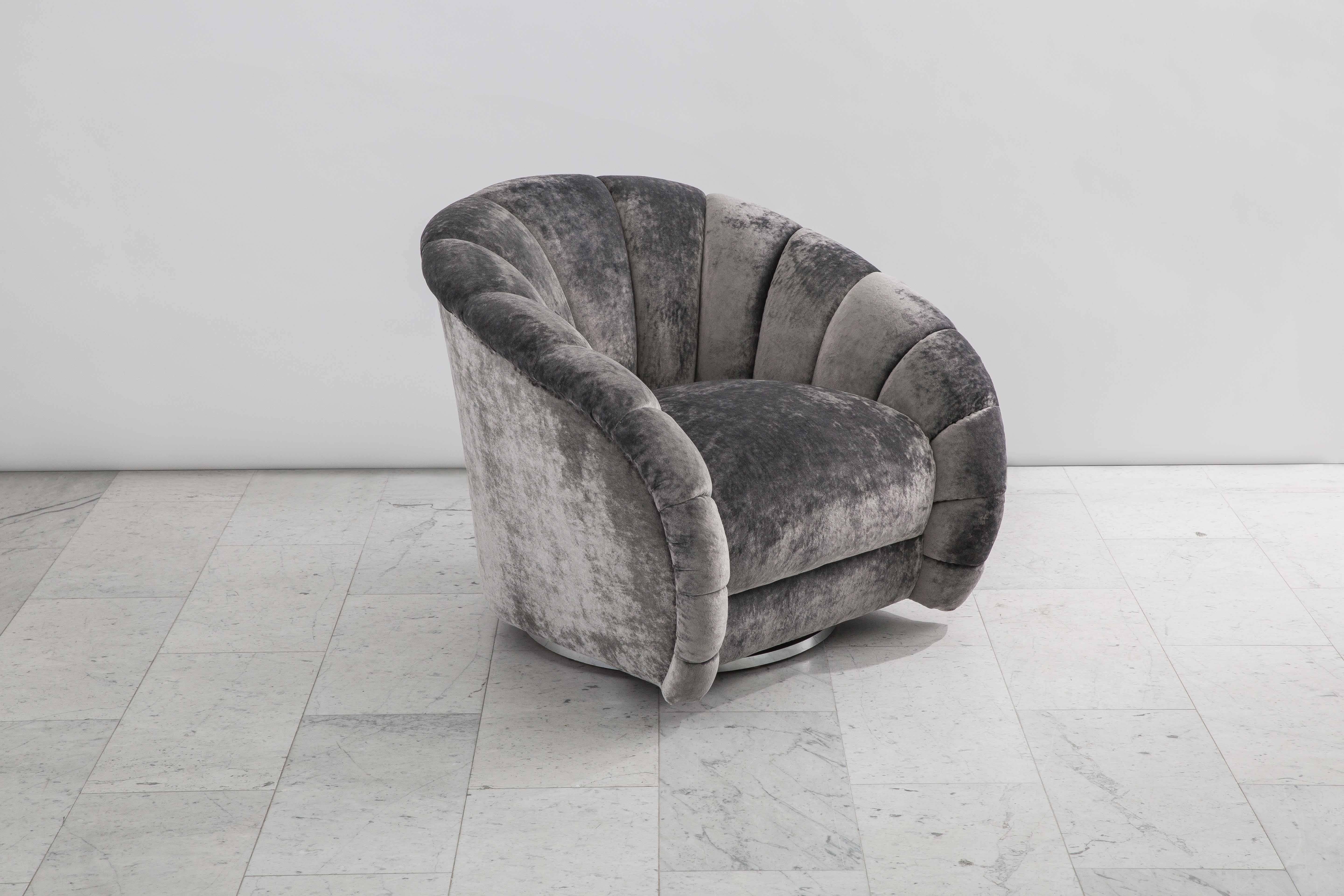 A beautiful pair of swivel chairs designed by Baughman, each has a circular chrome base that swivels with ease. Elegant in design, with a shell shaped back and armrest, they are also extremely comfortable, offering ideal proportions and back