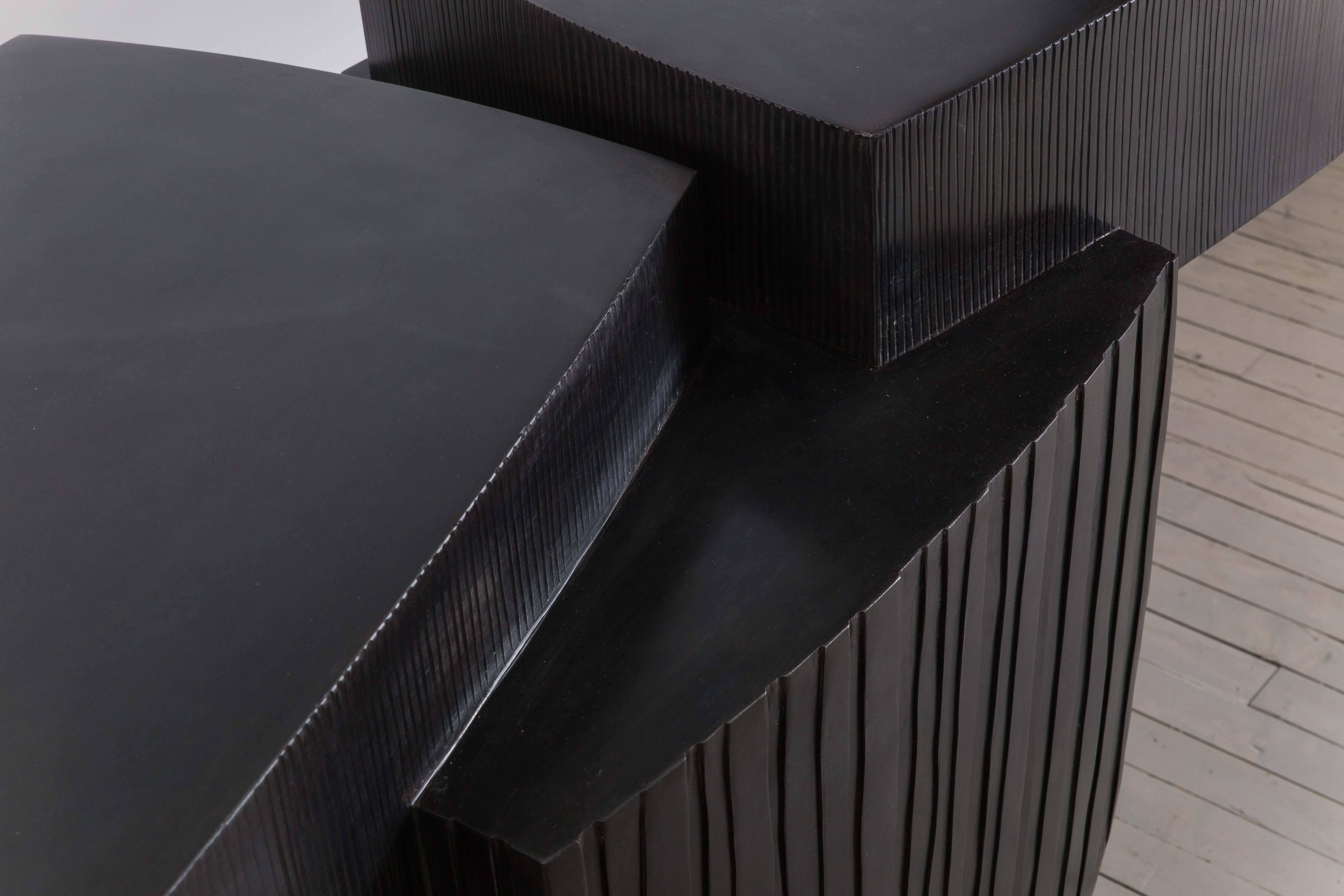 Gary Magakis’ unique blackened steel ledges console epitomizes the sculptor’s distinct approach to creating bold and dense geometric forms that simultaneously exude an elegant, buoyant aesthetic of Modernism. At once a functional console table and