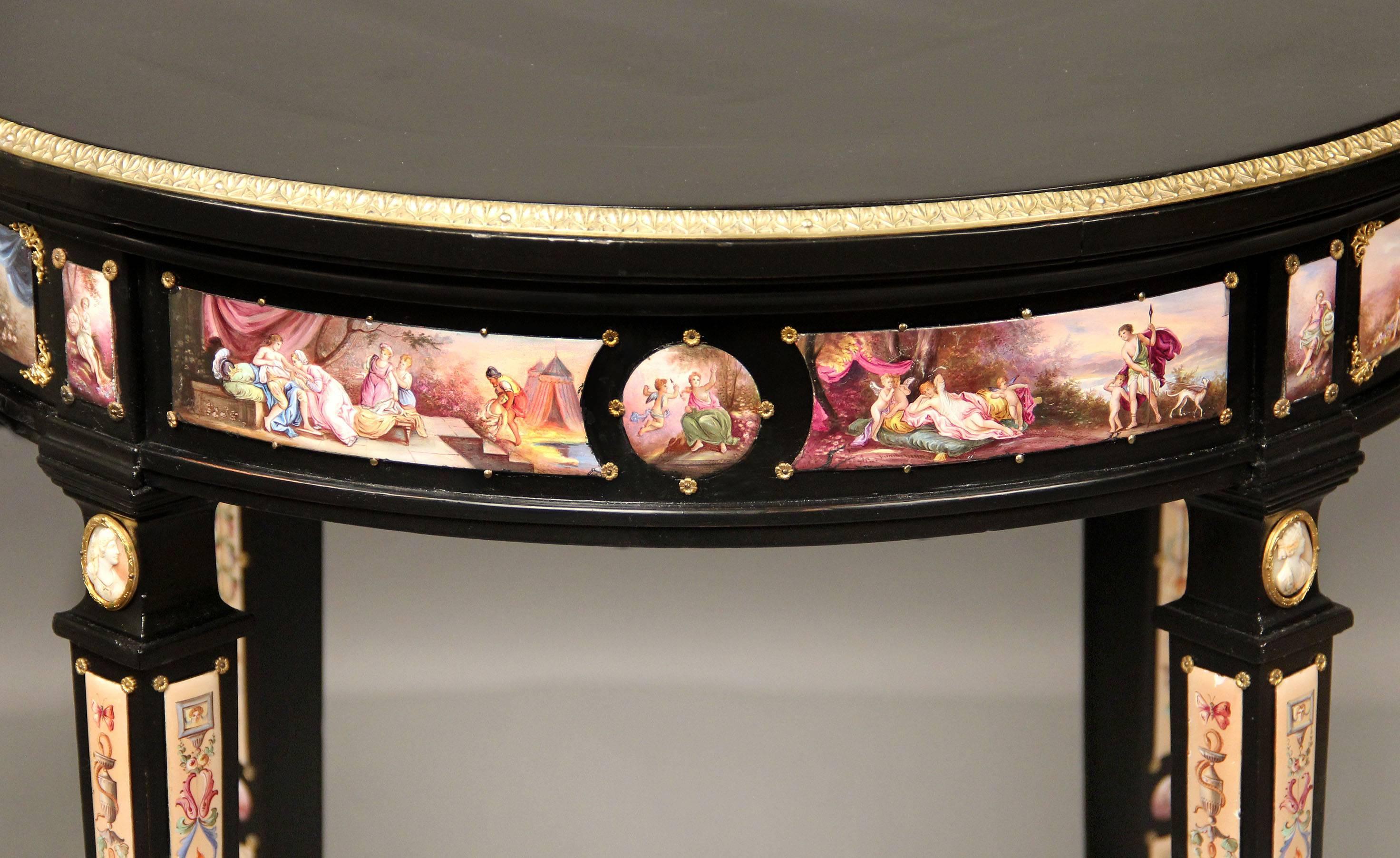 A rare and special late 19th century Louis XVI style gilt bronze and Viennese enamel mounted lacquered lamp table.

A lacquered wood top above a single center drawer, mounted with numerous enamel plaques depicting figural and mythological scenes.