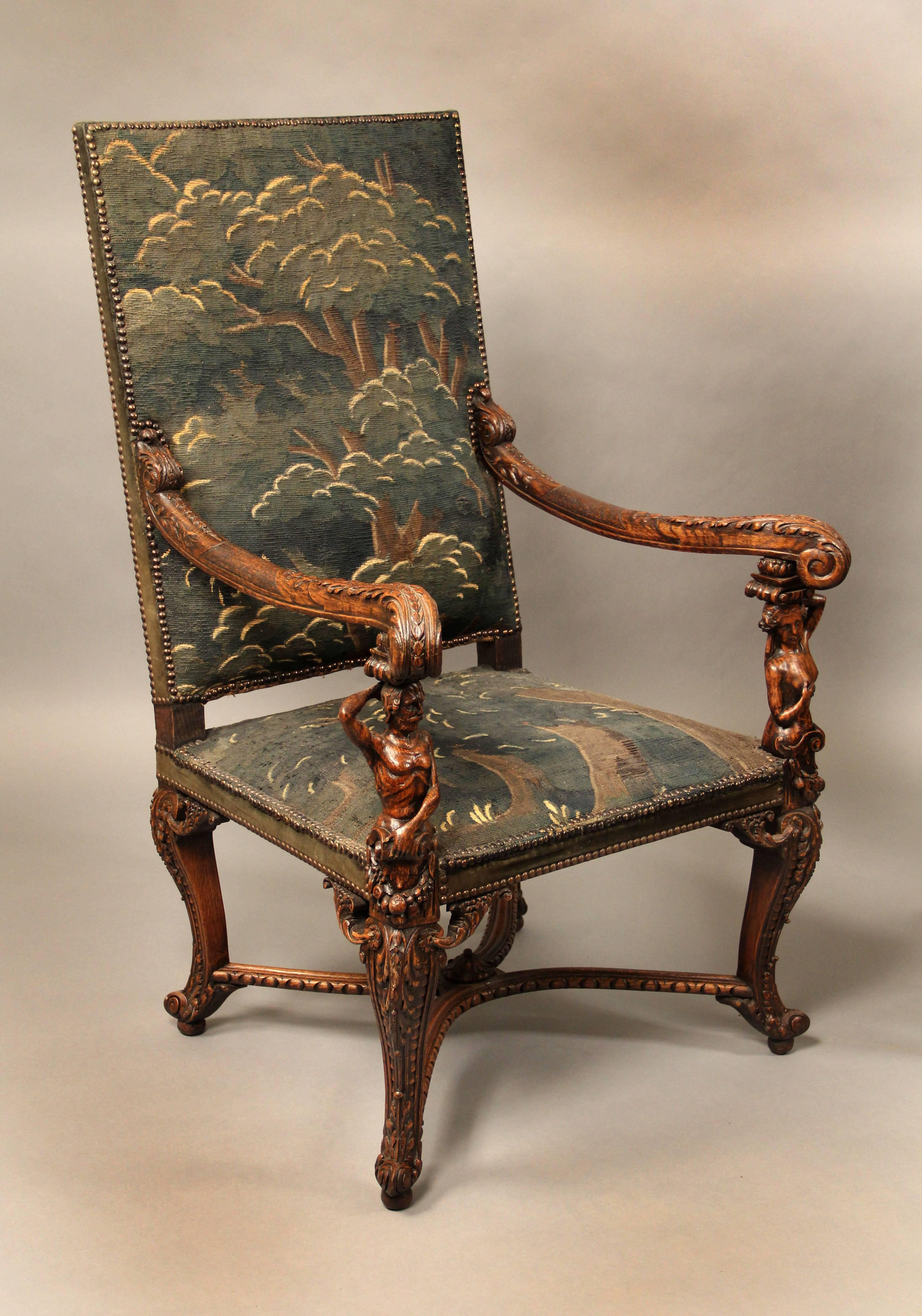 A fine pair of late 19th century carved wood armchairs.

Each chair with carved figures of a man or a woman supporting an arm.