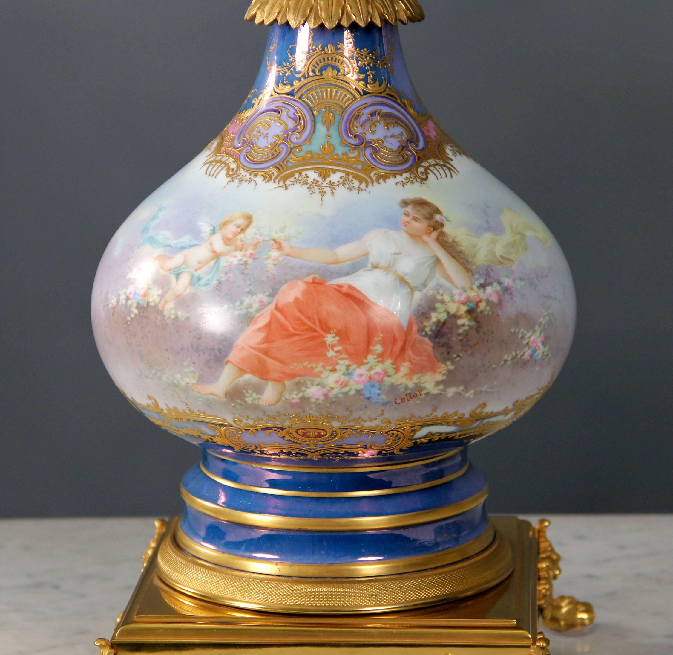 A beautiful late 19th century gilt bronze-mounted sèvres style porcelain lamp.

Raised gilt decorations, the front scene is of a reclining maiden among flowers being attended by cupid, the reverse a painting of cupid among flowers.

In late