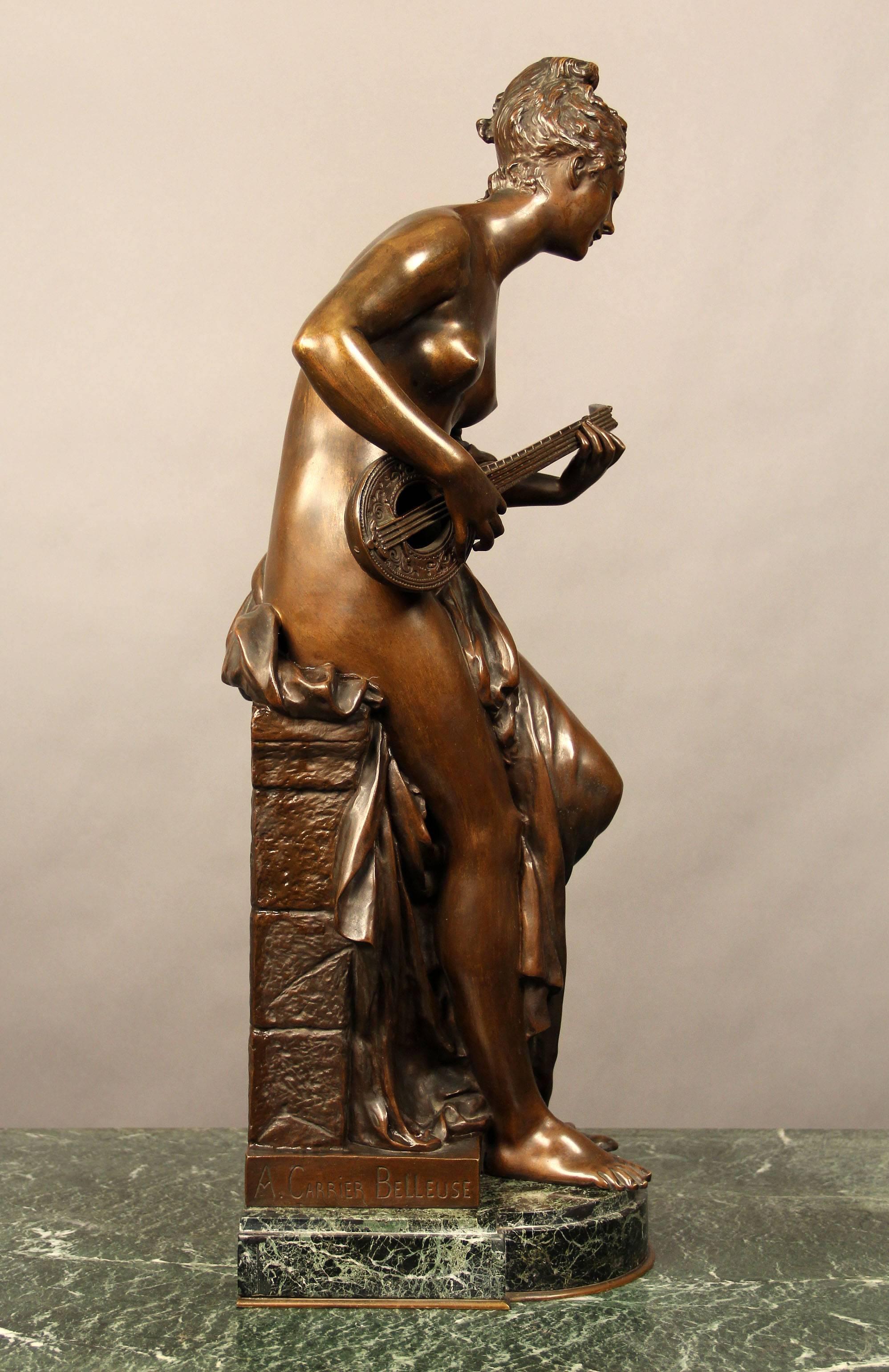 A late 19th century French bronze figure of a mandolin player.

Entitled "CIGALE".

By a Carrier Belleuse.

The scantily clad female muse shown seated on a rockwork plinth, verde antico marble base
 
Albert Ernest Carrier-Belleuse was born
