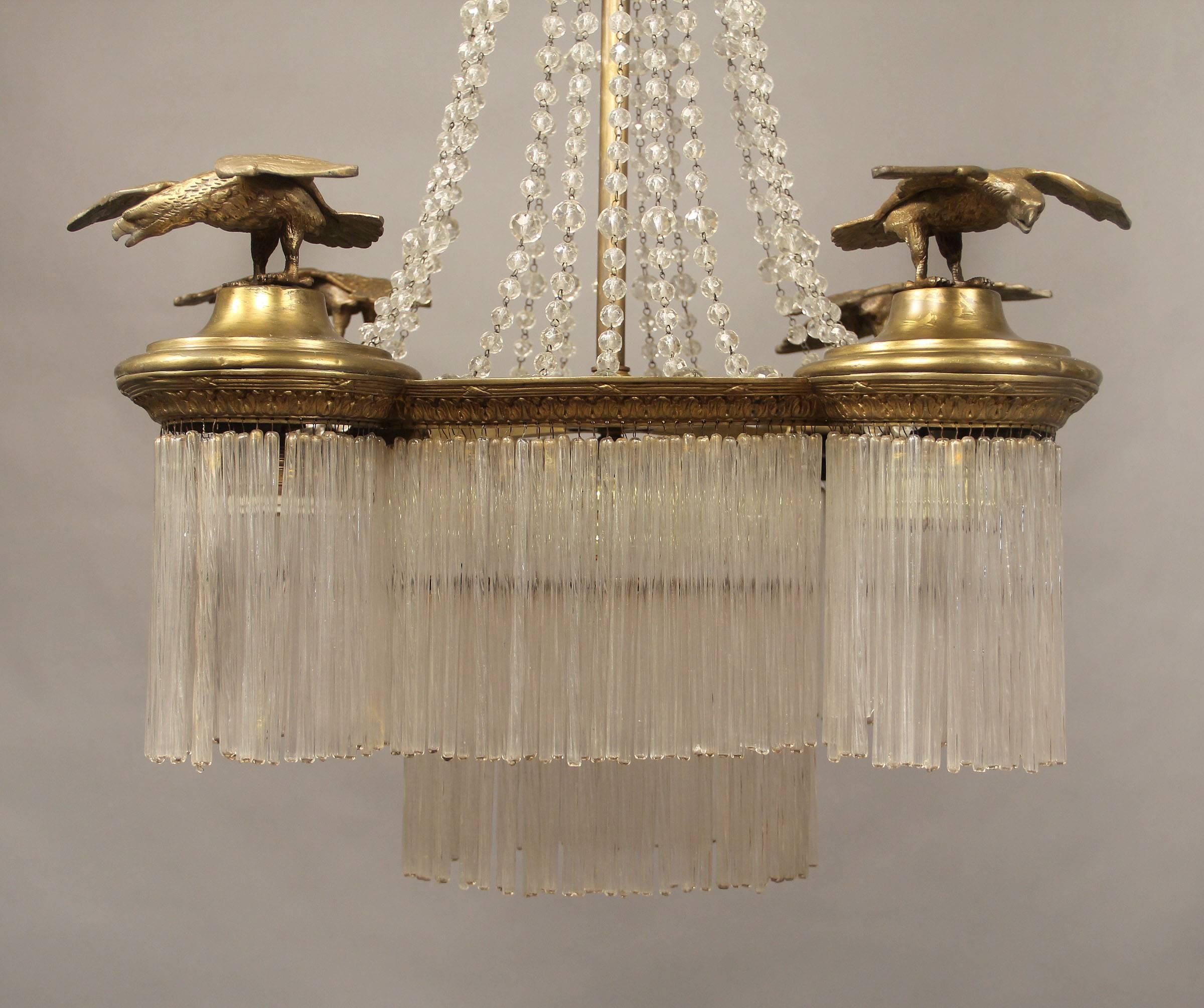 An interesting late 19th century gilt bronze and crystal five-light Empire style chandelier.

Beaded strings along the body with drop crystals, four bronze eagles adorning each corner. Five interior lights.

If you are looking for a chandelier,