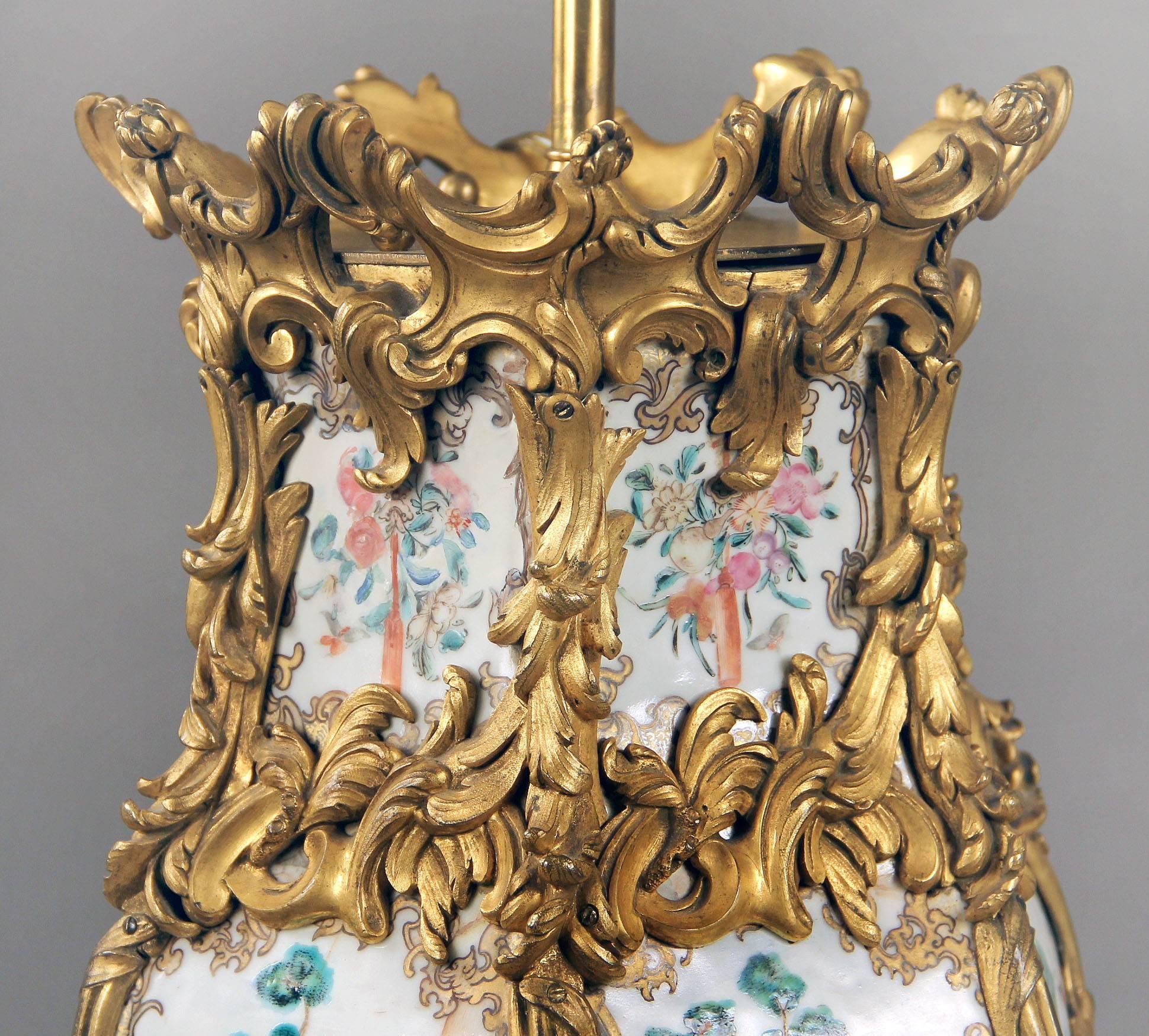 A nice quality pair of late 19th century French gilt bronze mounted Chinese porcelain lamps.

Fine bronze mounts separate the six painted panels decorated with chinoiserie figures in landscape and domestic scenes.