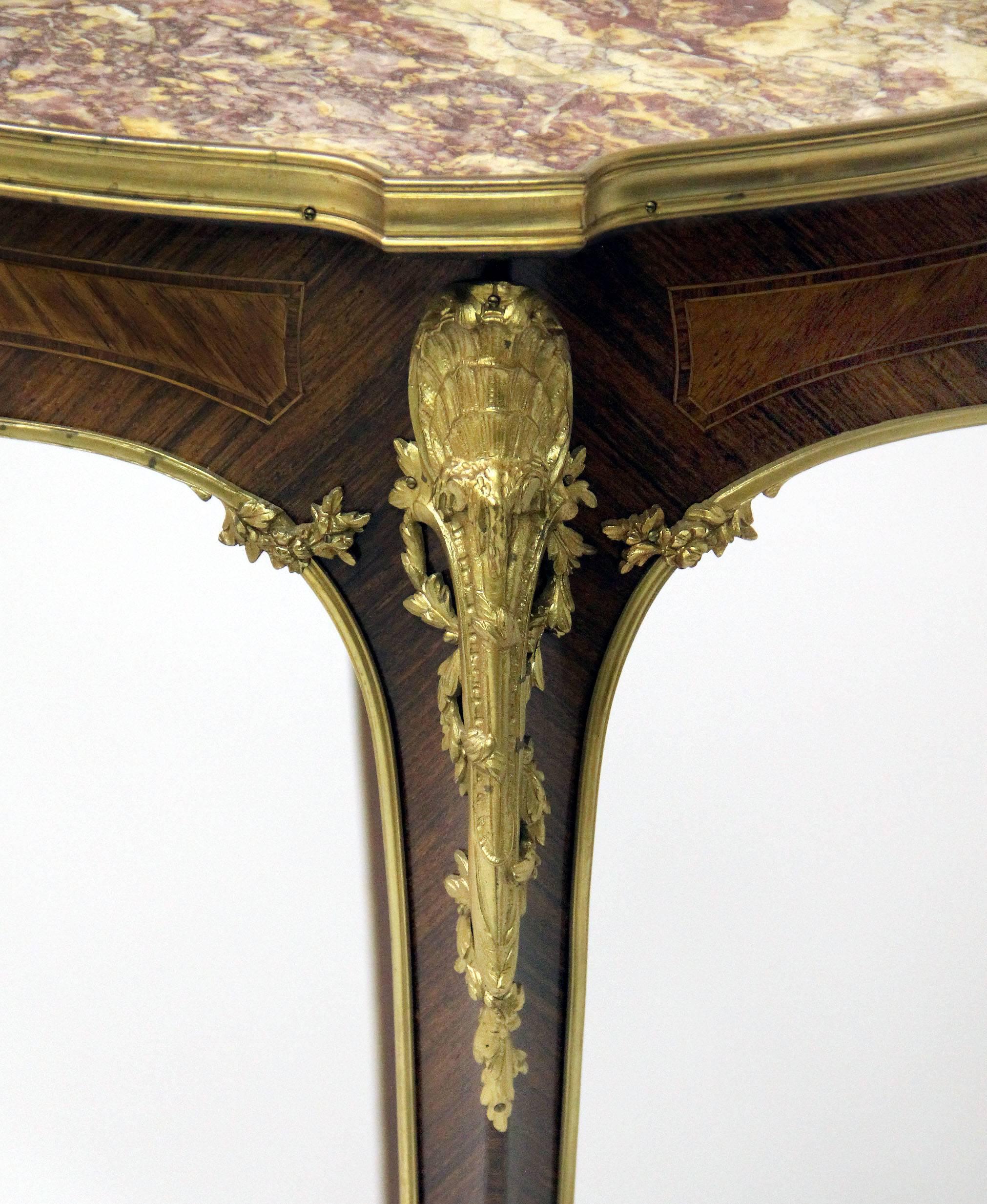 A wonderful late 19th century gilt bronze mounted Louis XV style parquetry lamp table

By Kahn

The marble top over cabriole legs with bronze mounts of sea shells and flowers.

The underside of the carcass labelled E. Kahn Paris.

E. Kahn &