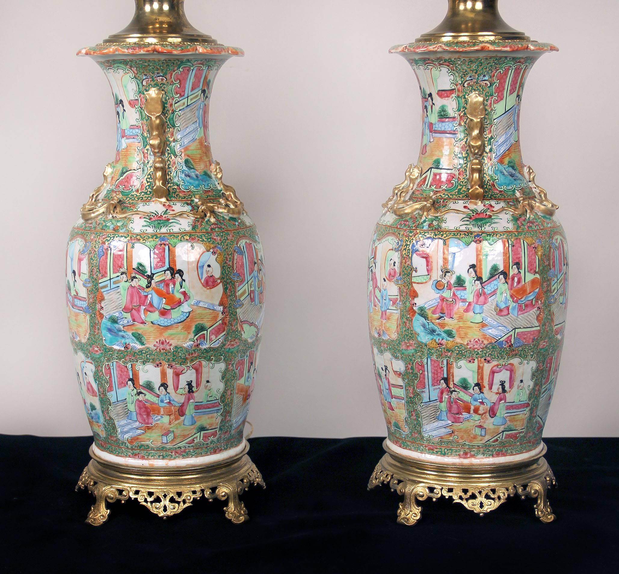 A pair of late 19th century French gilt bronze-mounted Chinese Canton porcelain lamps

Painted interior scenes with many people, each separated by floral designs, the neck with gilded monkeys and lizards, and sitting on a bronze base.

Measures: