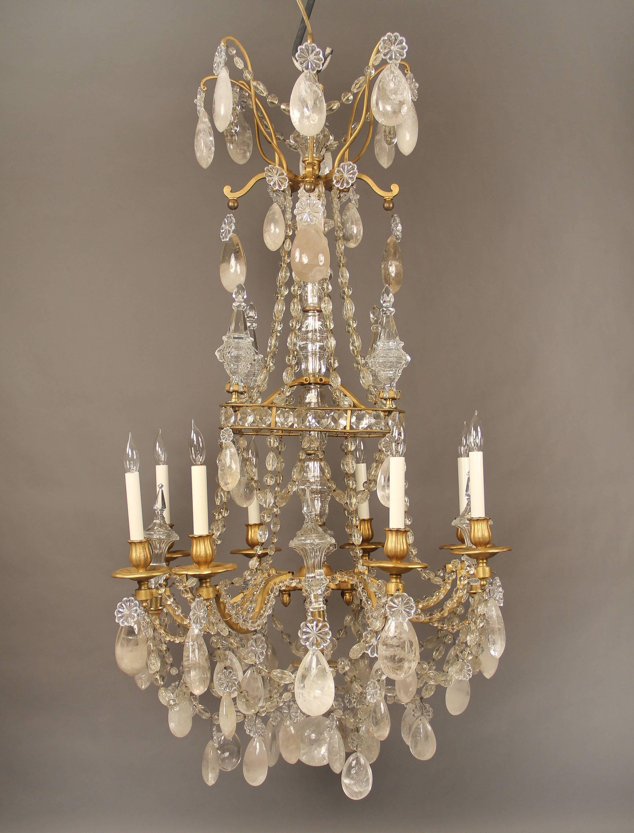 A lovely late 19th century gilt bronze and rock crystal eight-light chandelier.

Attributed to Gagneau Frères.

Full pear shaped and tear drop rock crystal, beaded arms and swags, eight-tiered spears, cut crystal central column.

The