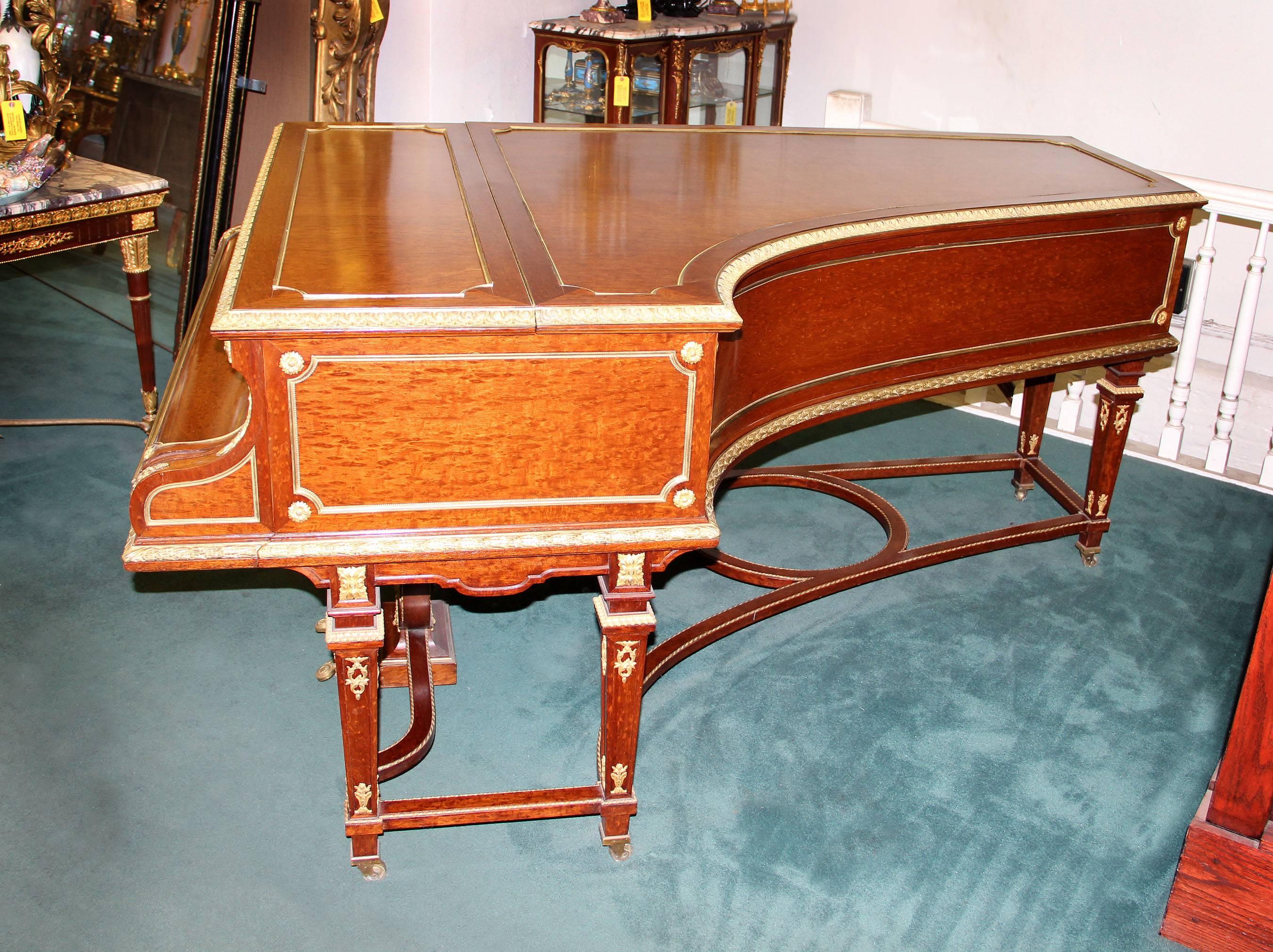 A wonderful turn-of-the-century gilt bronze mounted Louis XVI style six leg grand Erard Piano.

Beautiful plum mahogany veneer. Great quality floral and women bronze mounts, standing on six legs centered by a stretcher.

Erard serial number