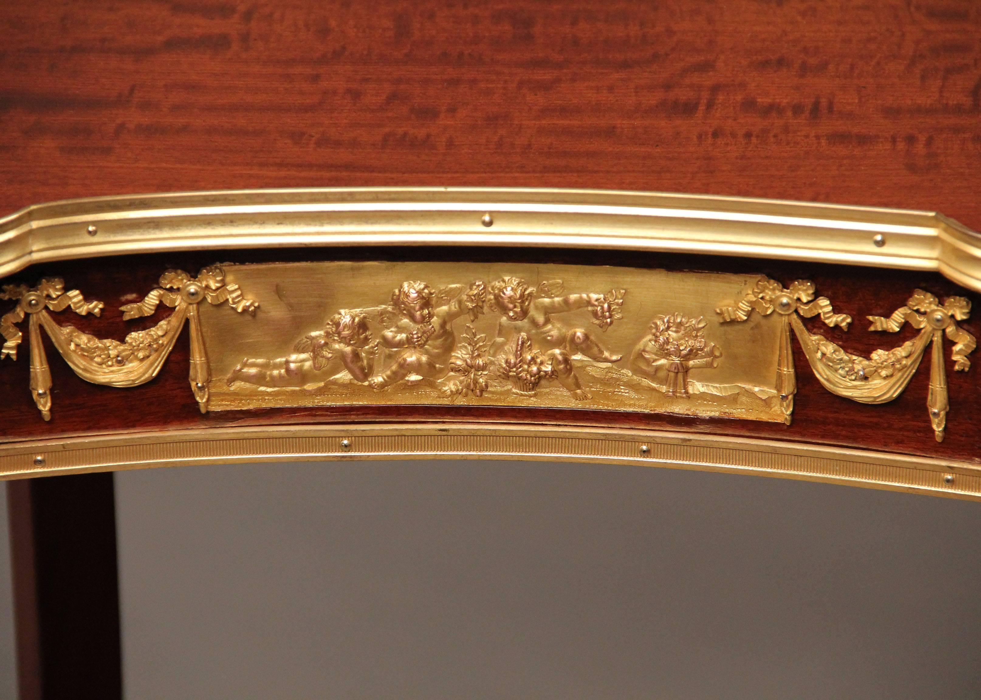 A fine late 19th century Transitional style gilt bronze-mounted kidney shaped table.

The frieze fitted with one drawer, the stretcher with a heart-shaped cast gallery.