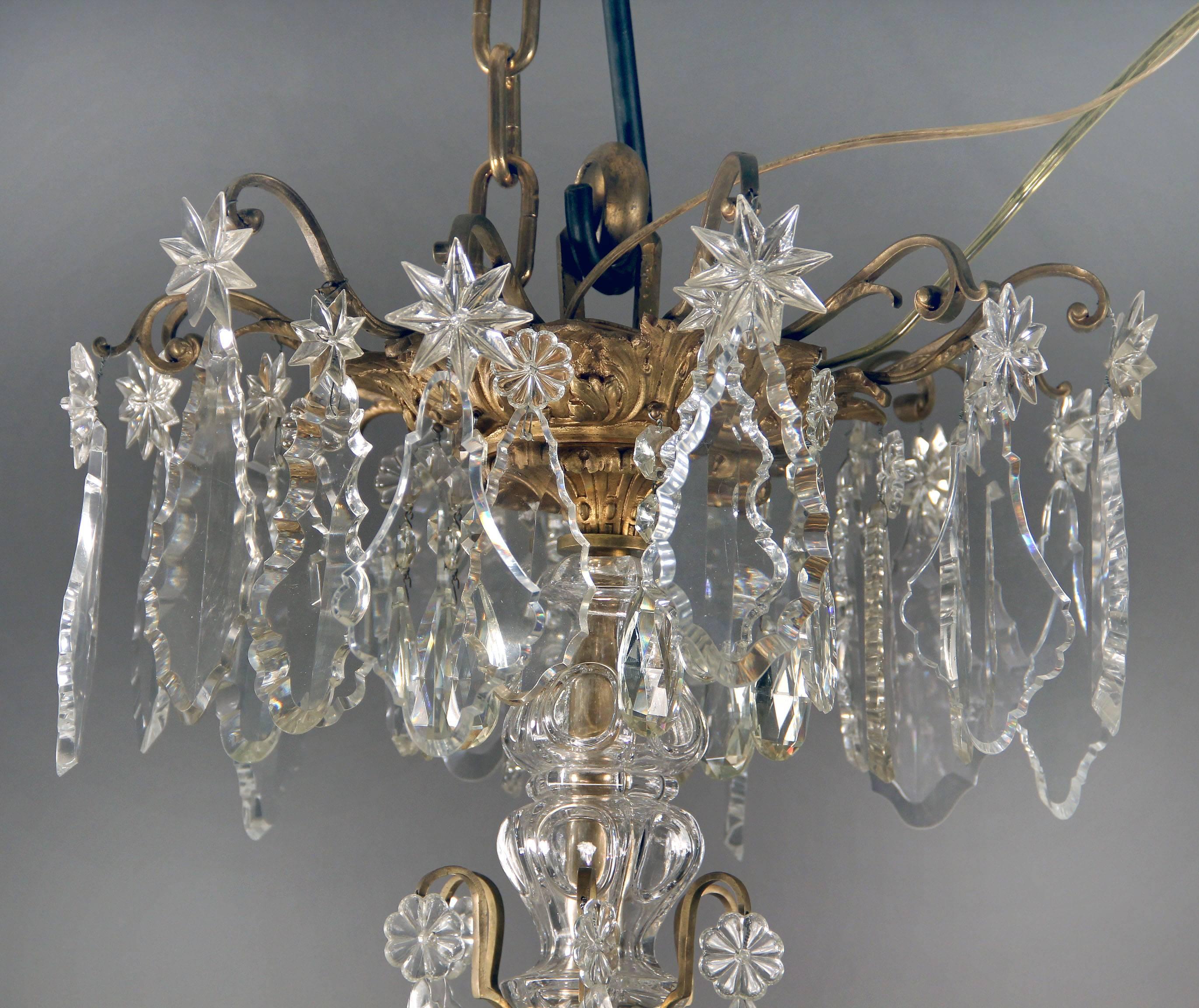 A large and fantastic late 19th century gilt bronze and Baccarat crystal thirty-light chandelier.

Multifaceted and shaped crystal, beaded arms with crystal swags, cut crystal central column, six spears, twenty-four-tiered perimeter and six