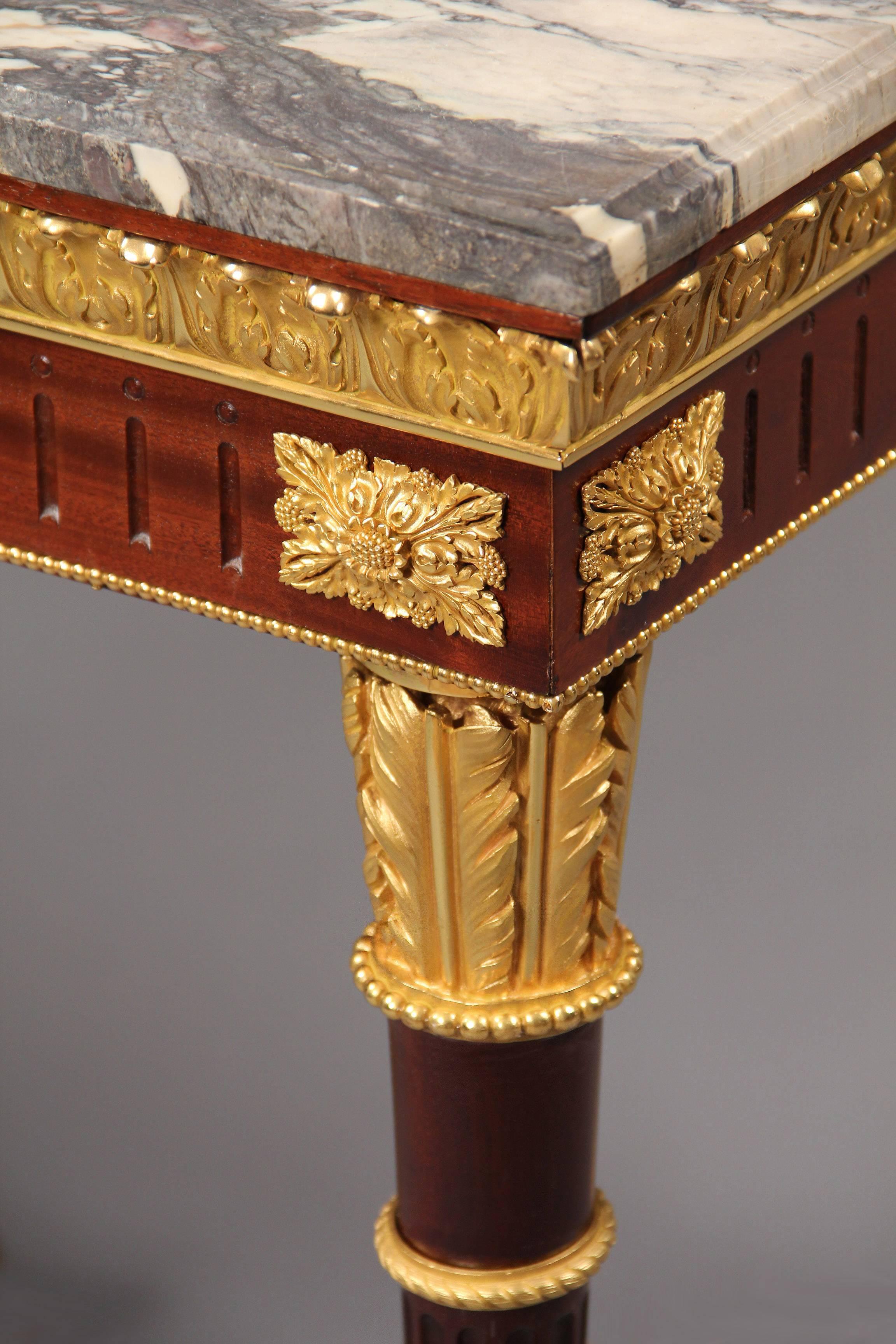 A Fantastic Quality Late 19th Century Louis XVI Style Gilt Bronze Mounted Center Table

 Marble top, above a bronze frieze, bronze mounted tapering legs joined by a bronze stretcher designed as a bow and arrow.