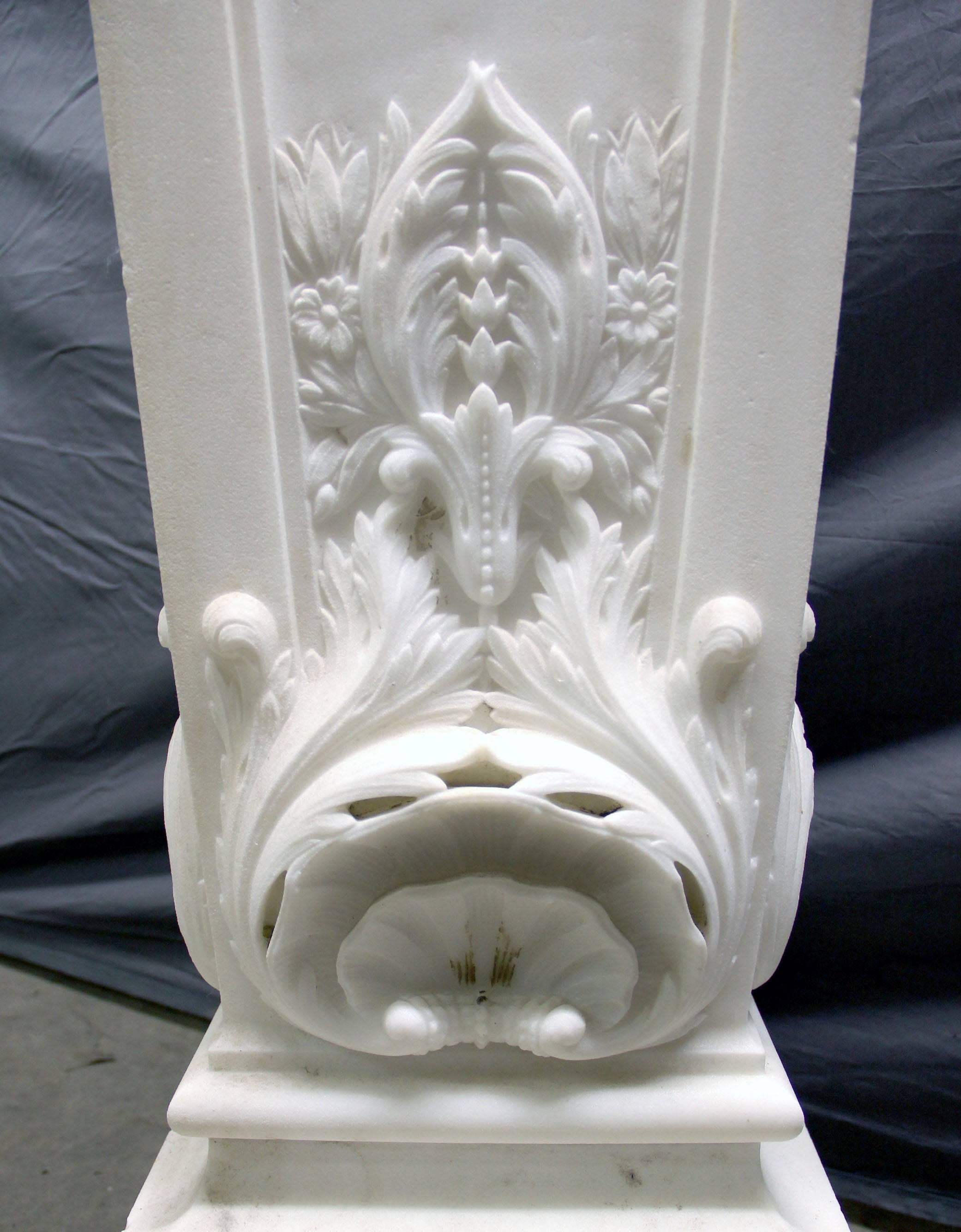A palatial pair of early 20th century carved white marble pedestals.