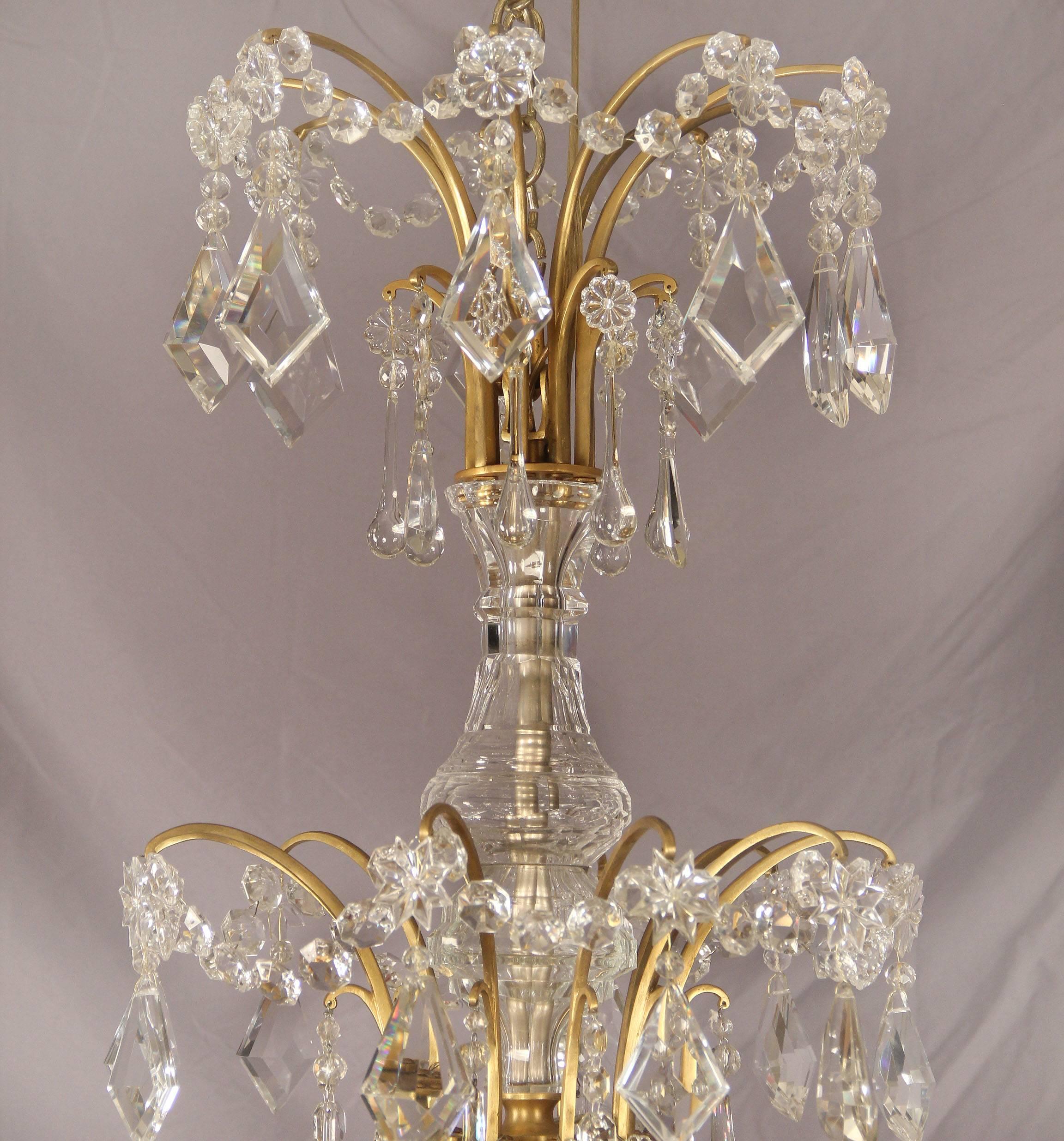 A palatial and unique late 19th century gilt bronze and crystal thirteen-light chandelier

by Maison Jansen, France.

Multi-faceted and shaped crystal, beaded swags and gilt chains throughout the entire chandelier. Twelve perimeter lights with