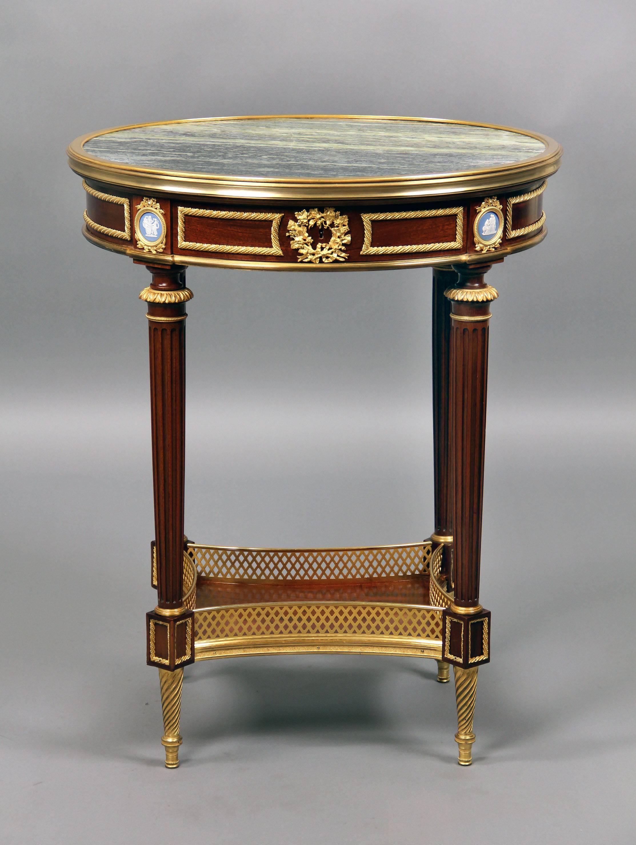 Fantastic quality early 20th century Louis XVI style gilt bronze mounted lamp table

by François Linke.

Insert marble-top above a single drawer, ribbed fluted legs beneath jasperware medallions with mythological scenes.

Lock engraved F.