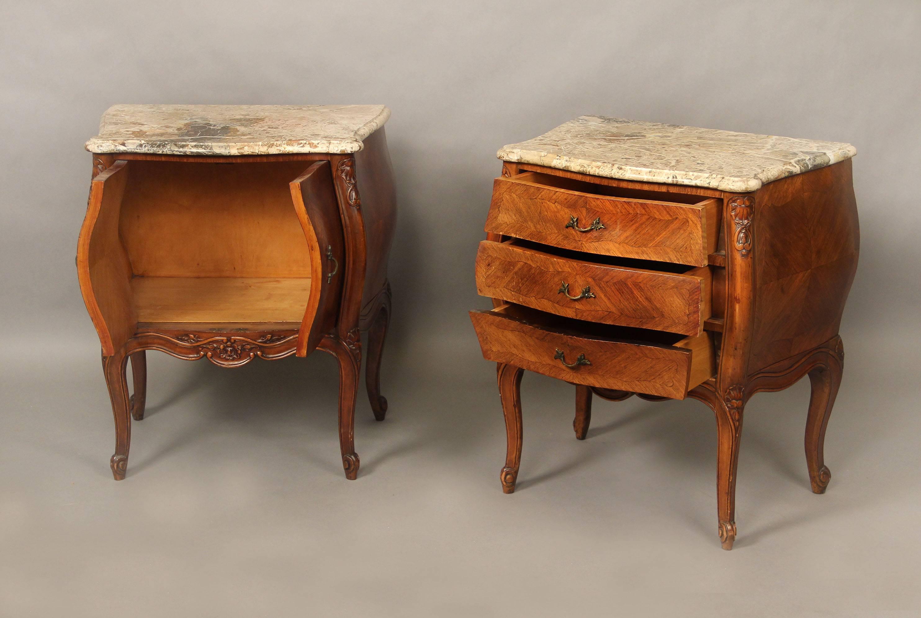 A pair of late 19th century Louis XV style carved wood night tables.

Finely veneered with marble tops. One night table with three drawers, the other with two doors.