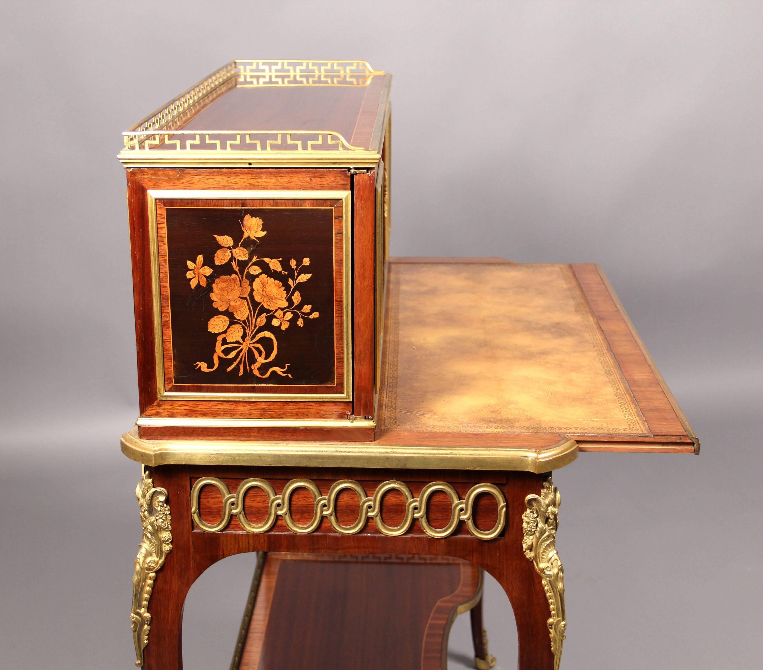 A fine mid-19th century Louis XV style gilt bronze-mounted marquetry desk

By Guillaume-Edmond Lexcellent

The upper structure consisting of two doors and a small drawer above a single long drawer, gilt bronze faces on each of the legs, the