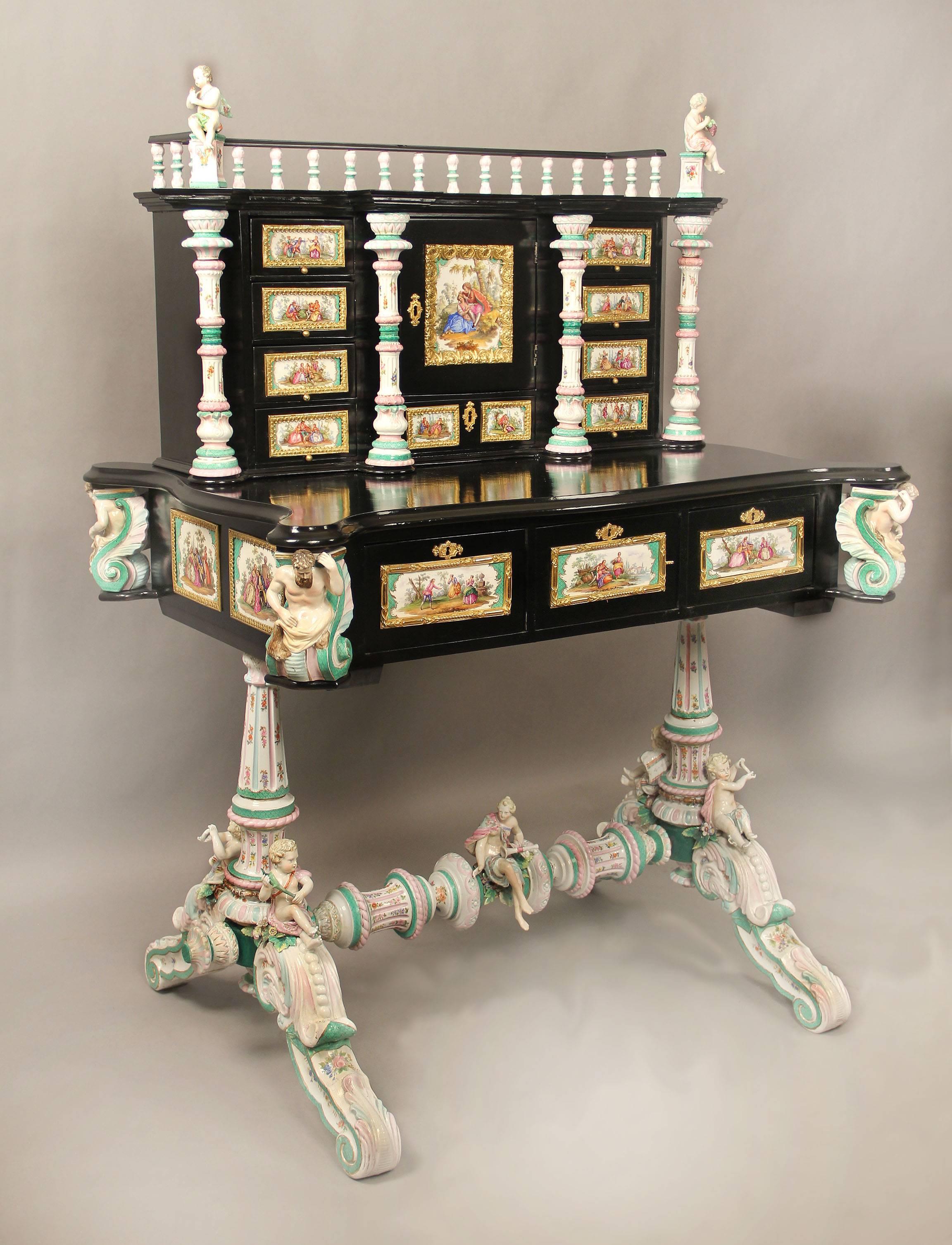 A lovely late 19th century gilt bronze-mounted German K.P.M. porcelain desk

Decorated all-over with porcelain plaques painted with scenes of courting couples, the upper section with a central cupboard door mounted with a square plaque and nine