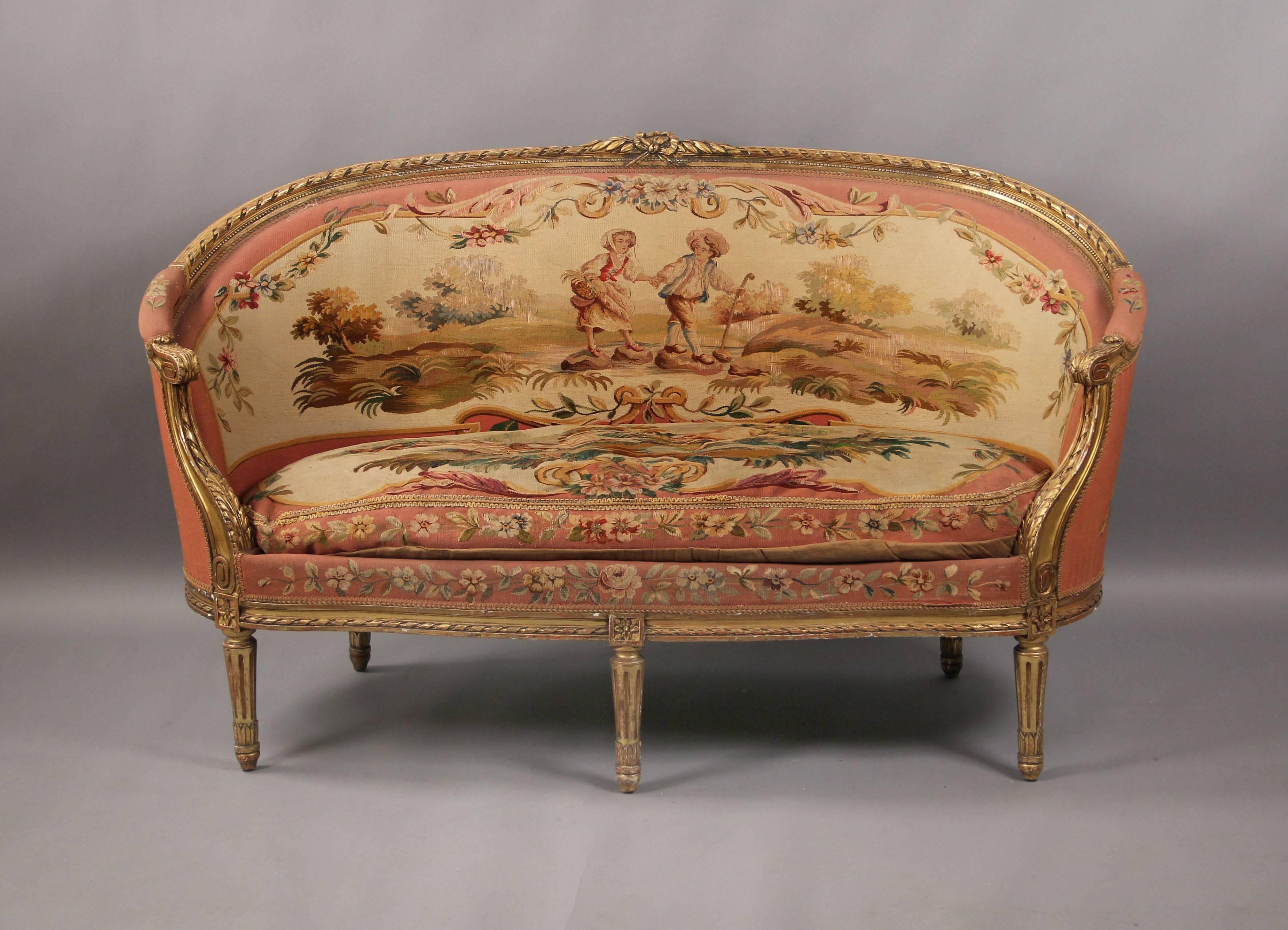 A beautiful late 19th century Louis XVI style five-piece carved giltwood Aubusson tapestry parlor set

Comprising of a settee and four armchairs.

Each with an oval upholstered back continuing to padded arms and an upholstered seat, raised on
