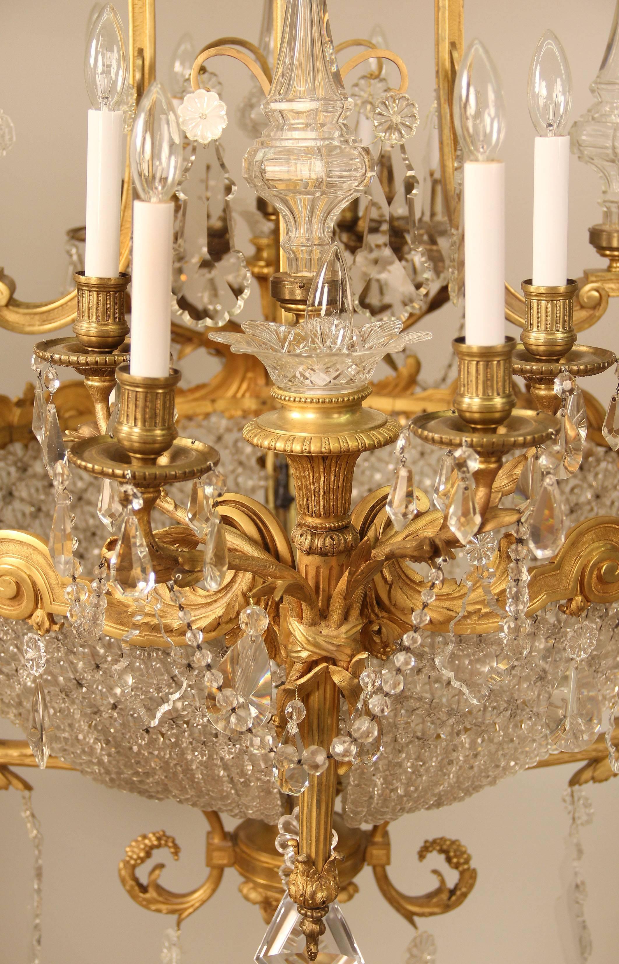 A unique and palatial late 19th century gilt bronze and cut crystal twenty-four-light basket chandelier

By Mottheau and Son Paris

Wonderful quality bronze casted cage in oval form, two arms shaped as torches with five lights and two as
