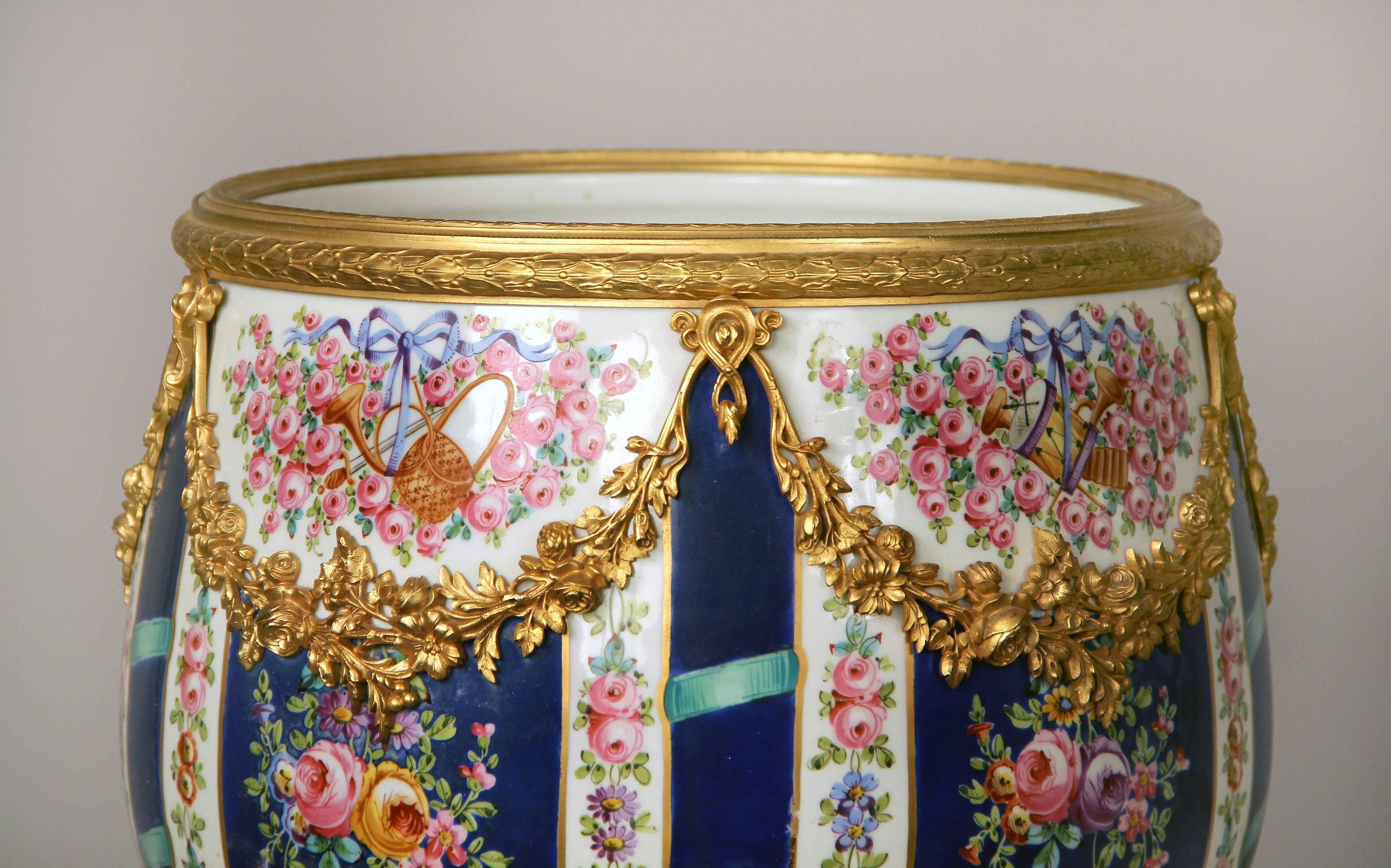 A fine late 19th century gilt bronze-mounted Sèvres style parcel-gilt porcelain jardinière

Finely painted with instruments, trophies and roses, mounted by bronze flowers and garlands.

In late 1739-early 1740 the Sèvres Porcelain Factory opened