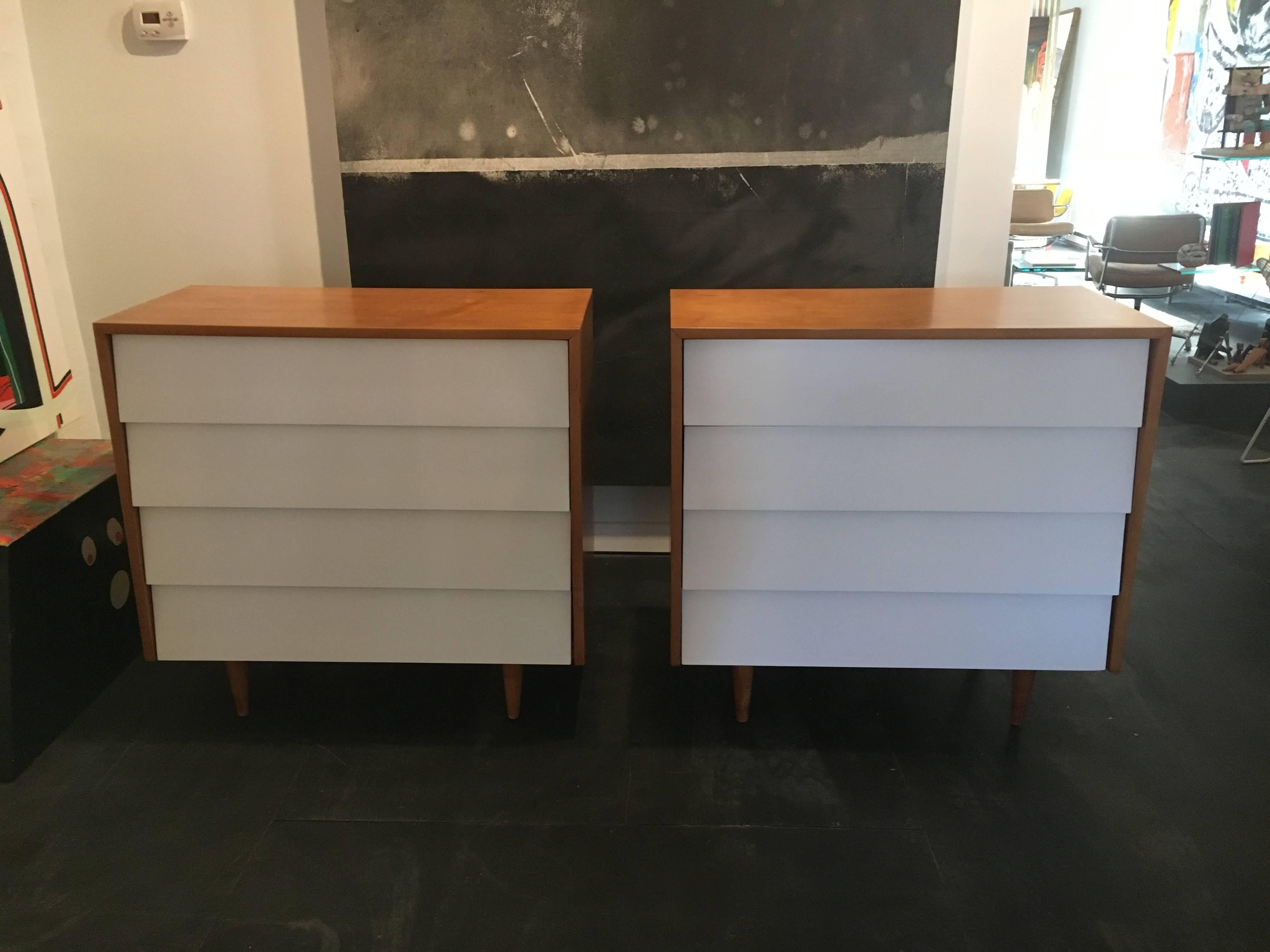 Pair of early four-drawer chests with white lacquer fronts, designed by Florence Knoll for Knoll, circa 1950.