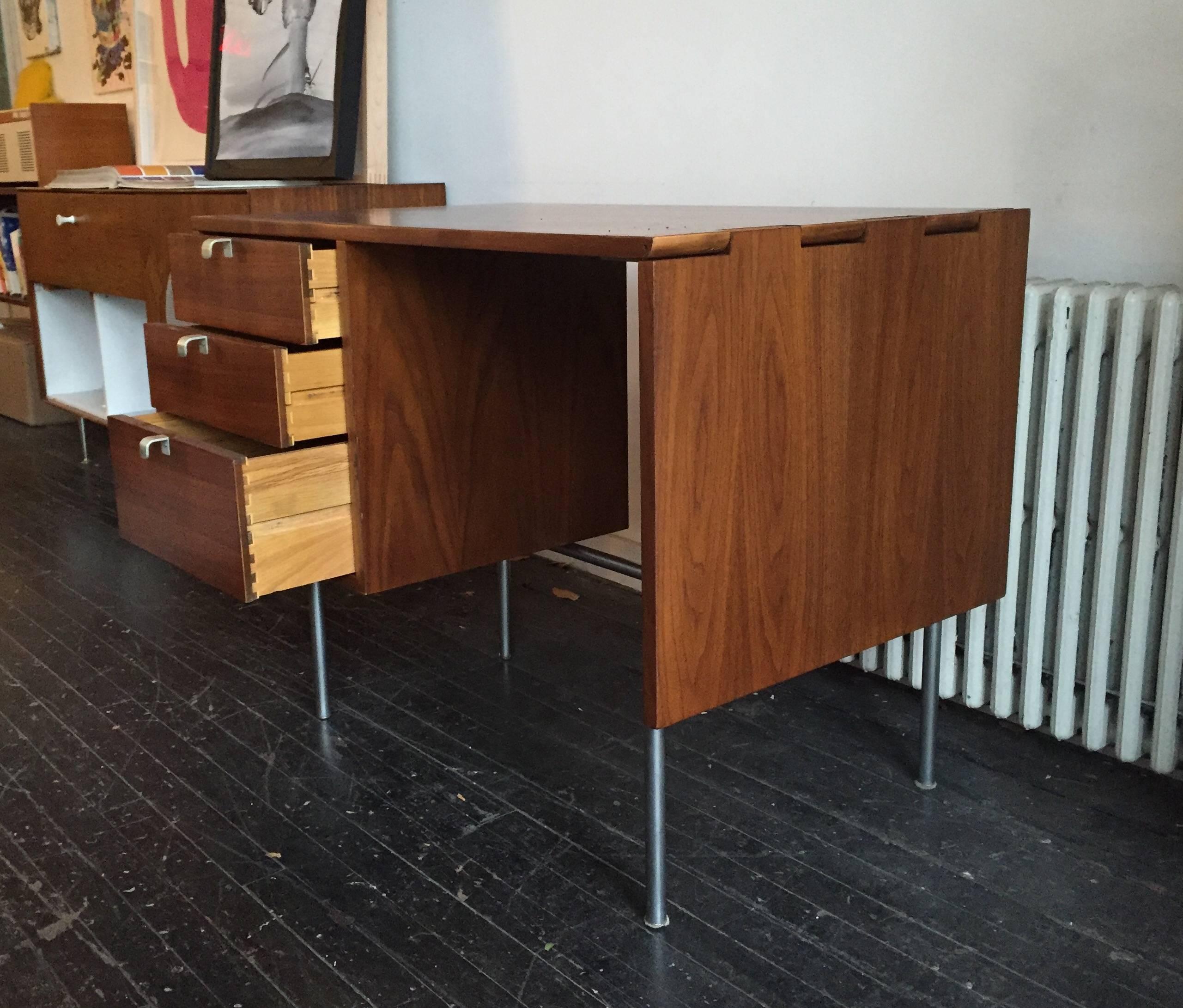 Drop Leaf Desk designed by George Nelson for Herman Miller, 1950ca. Satin chrome legs and J pulls, walnut and stainless steel. 

With the Drop Leaf extended the length of the top is 58 3/16 in.