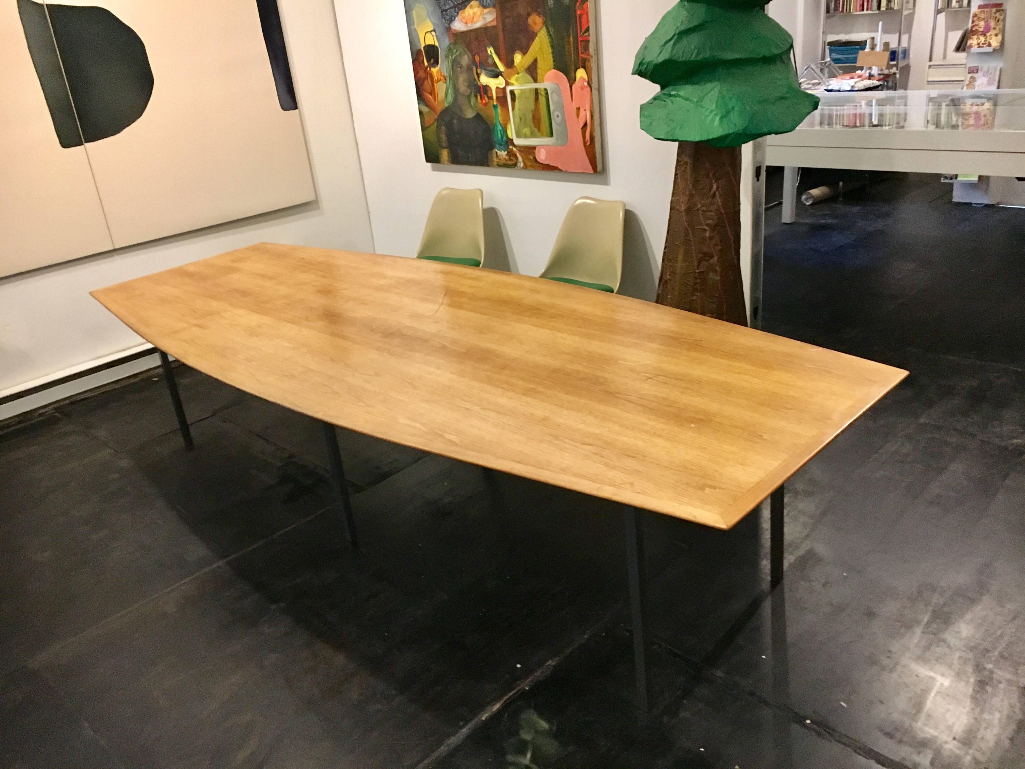 Boat shaped dining or conference table designed by Florence Knoll for Knoll.
Oak to and steel. Measures: 124" Long.