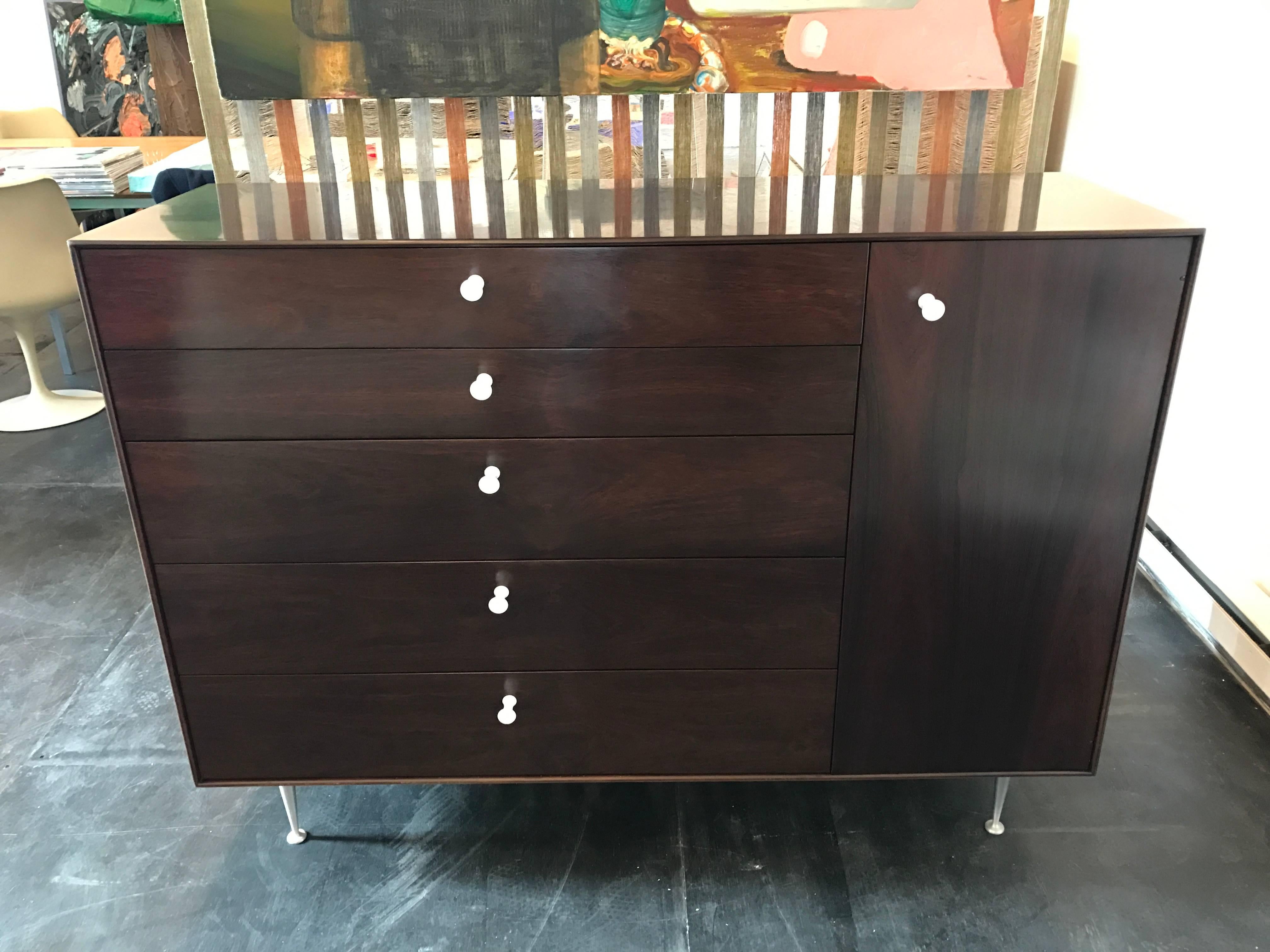 Rosewood thin edge cabinet, chest of drawers with ceramic pulls and two adjustable shelfs, designed by George Nelson for Herman Miller in 1955.