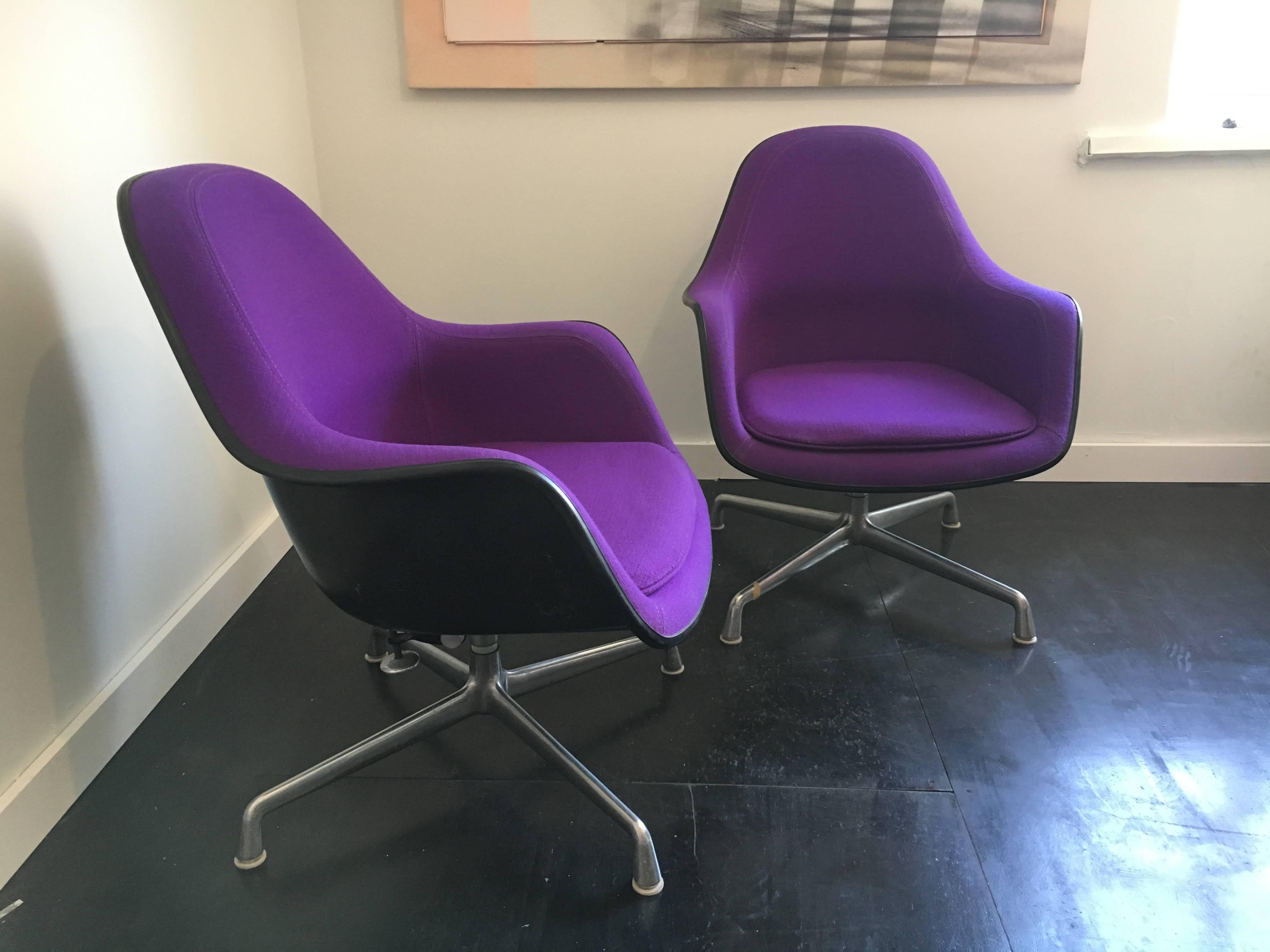 Rare pair of lounge chairs designed by Charles & Ray Eames for Herman Miller. Black fiber glass shell upholstered in original Girard hopsack. Chairs swivel, adjustable seat height with tilt- base.

We have 2 pairs available, please contact us if