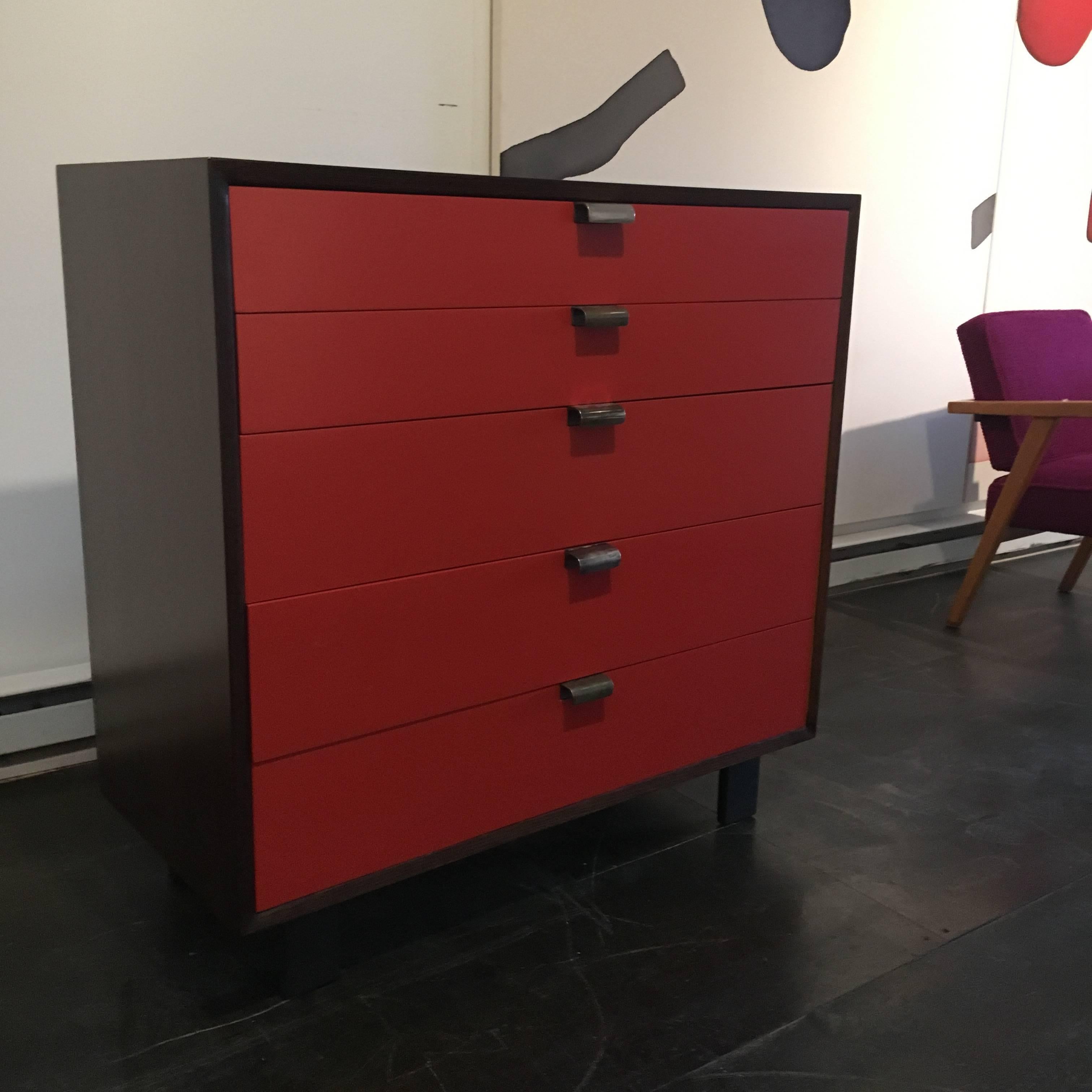 Chest of five drawers with lacquered red front and ebonized casing designed by George Nelson for Herman Miller in 1948.