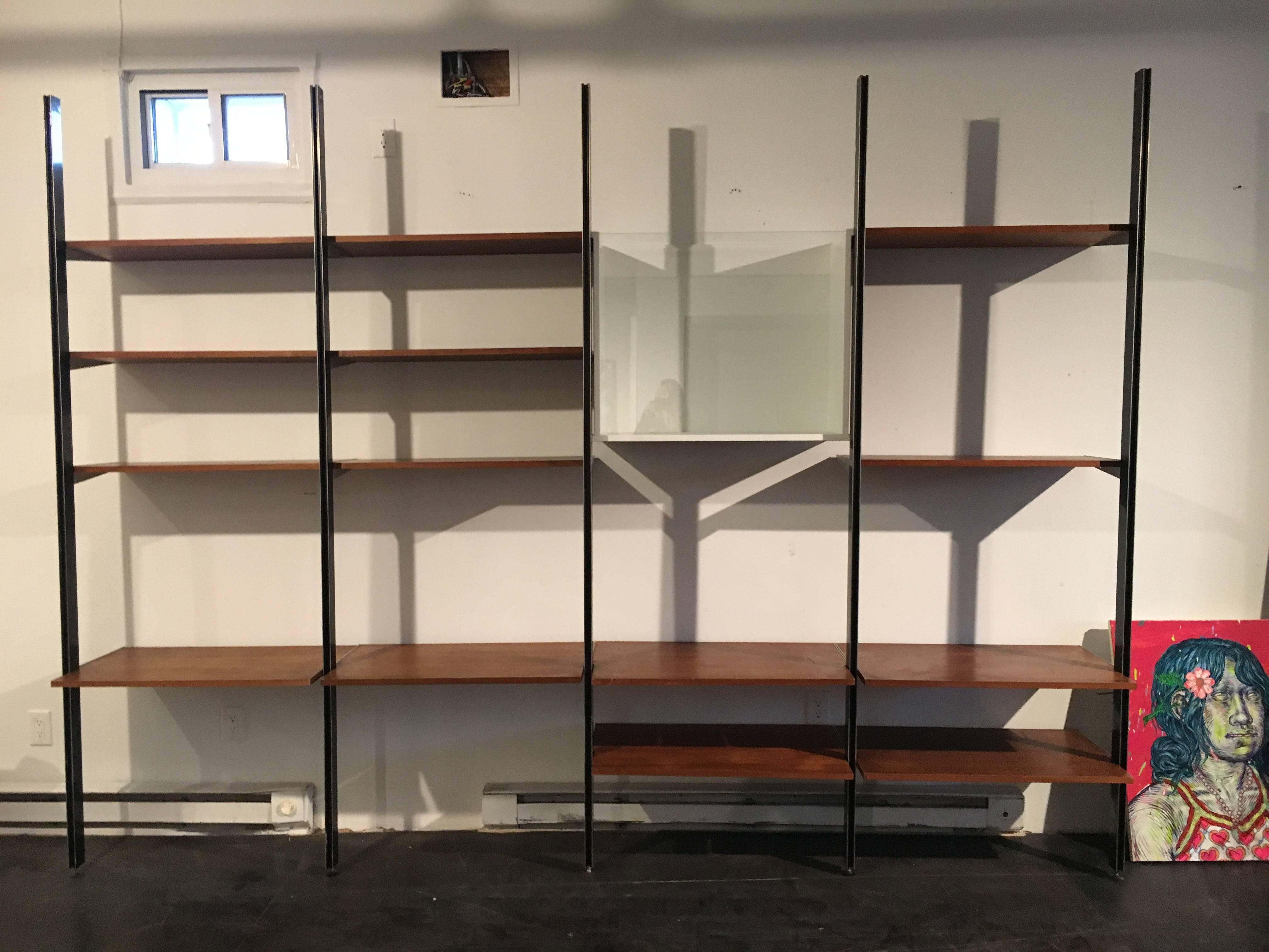 Four bay CSS (comprehensive storage system), designed by George Nelson for Herman Miller.
Walnut shelfs, rare glass front vitrine, all components are modular.