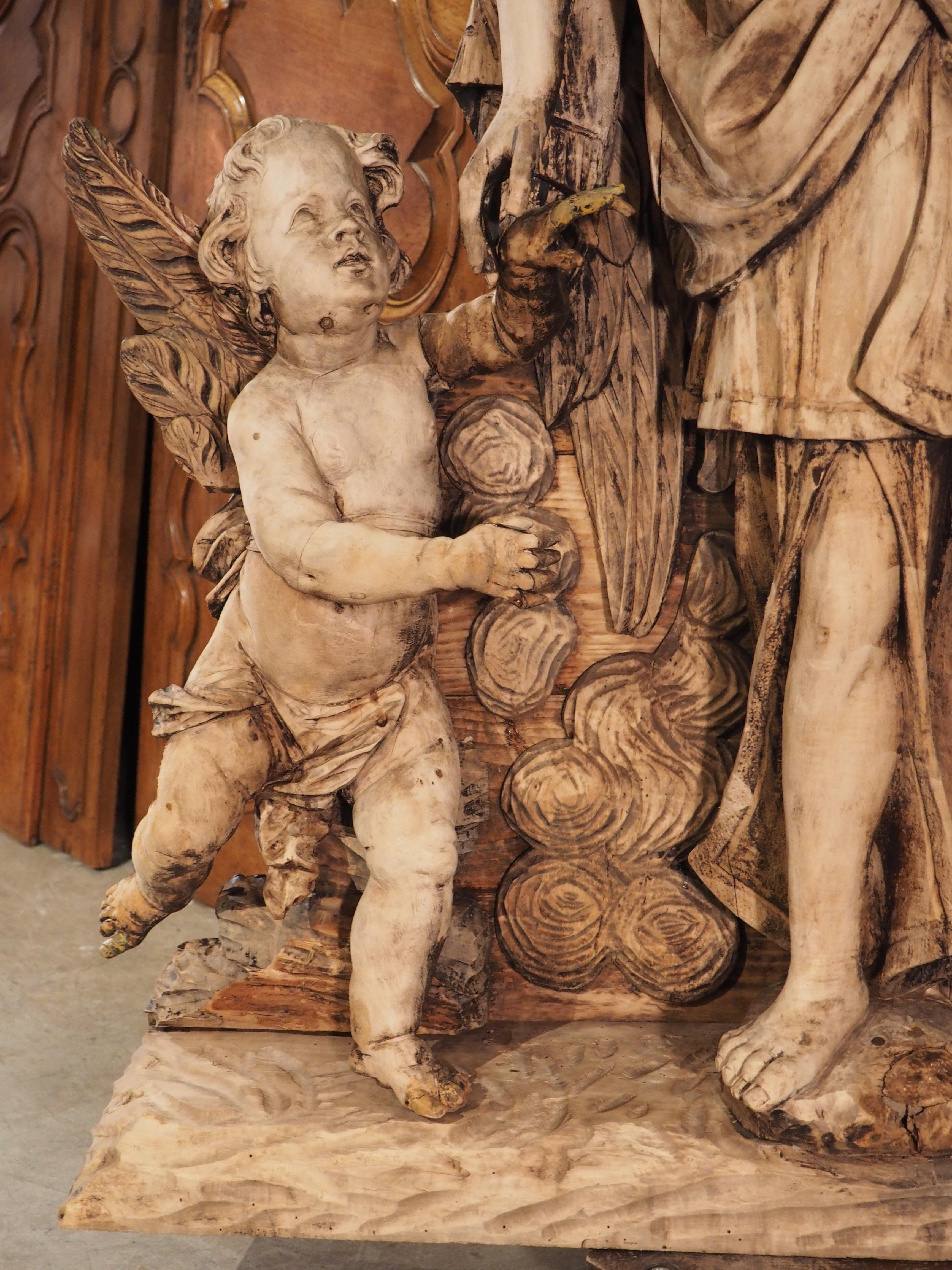 Bleached Large 18th Century Wooden Carving of an Angel with Cherubs For Sale