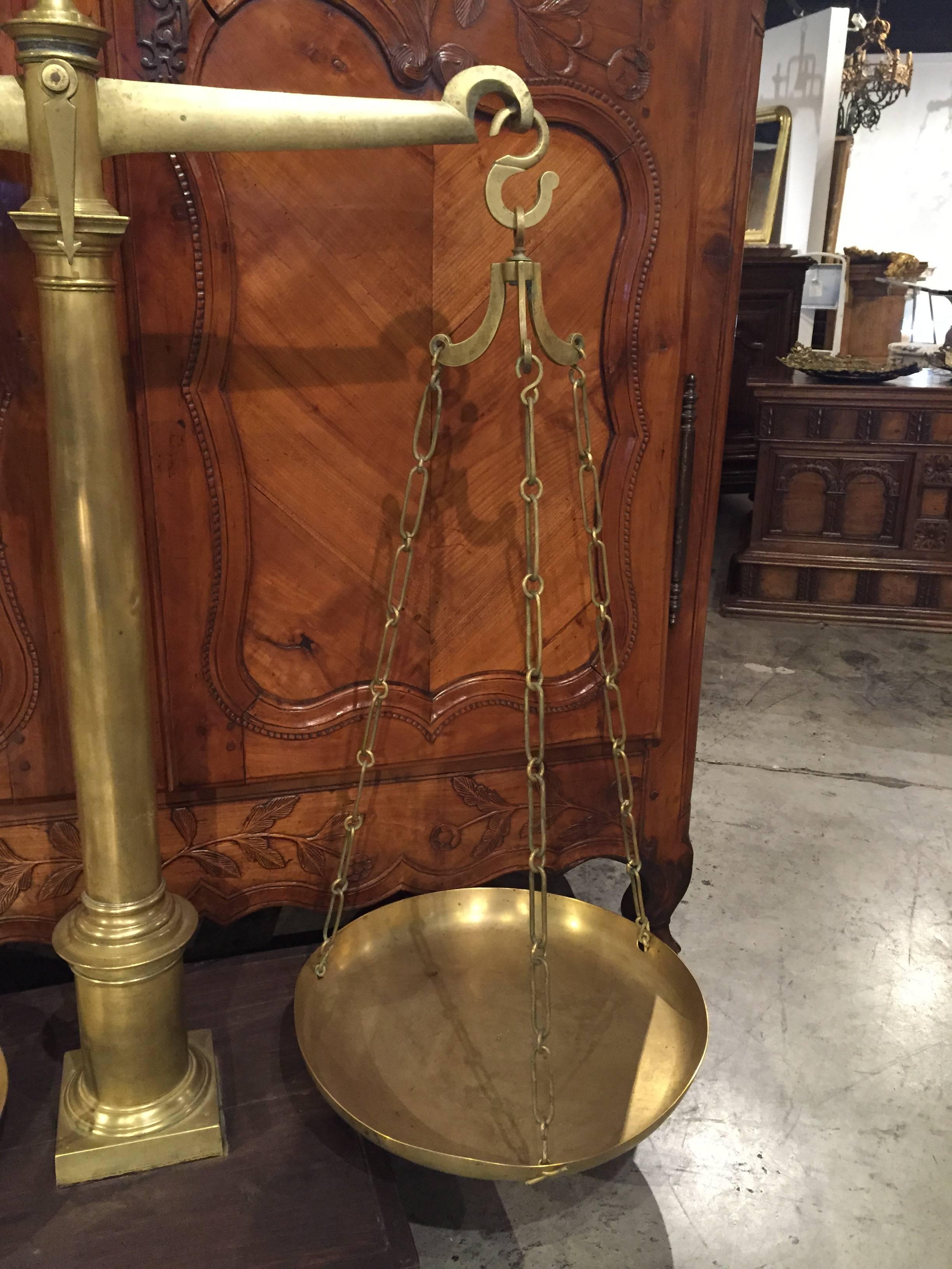 This large-scale was typical of the scales that pharmacists used in France in the 1800s. By removing the top piece, and inspecting the arm of the scale, you can see imprinted: LAMARE, R Dufour St Germain 24 Paris. The top has a ball finial with a