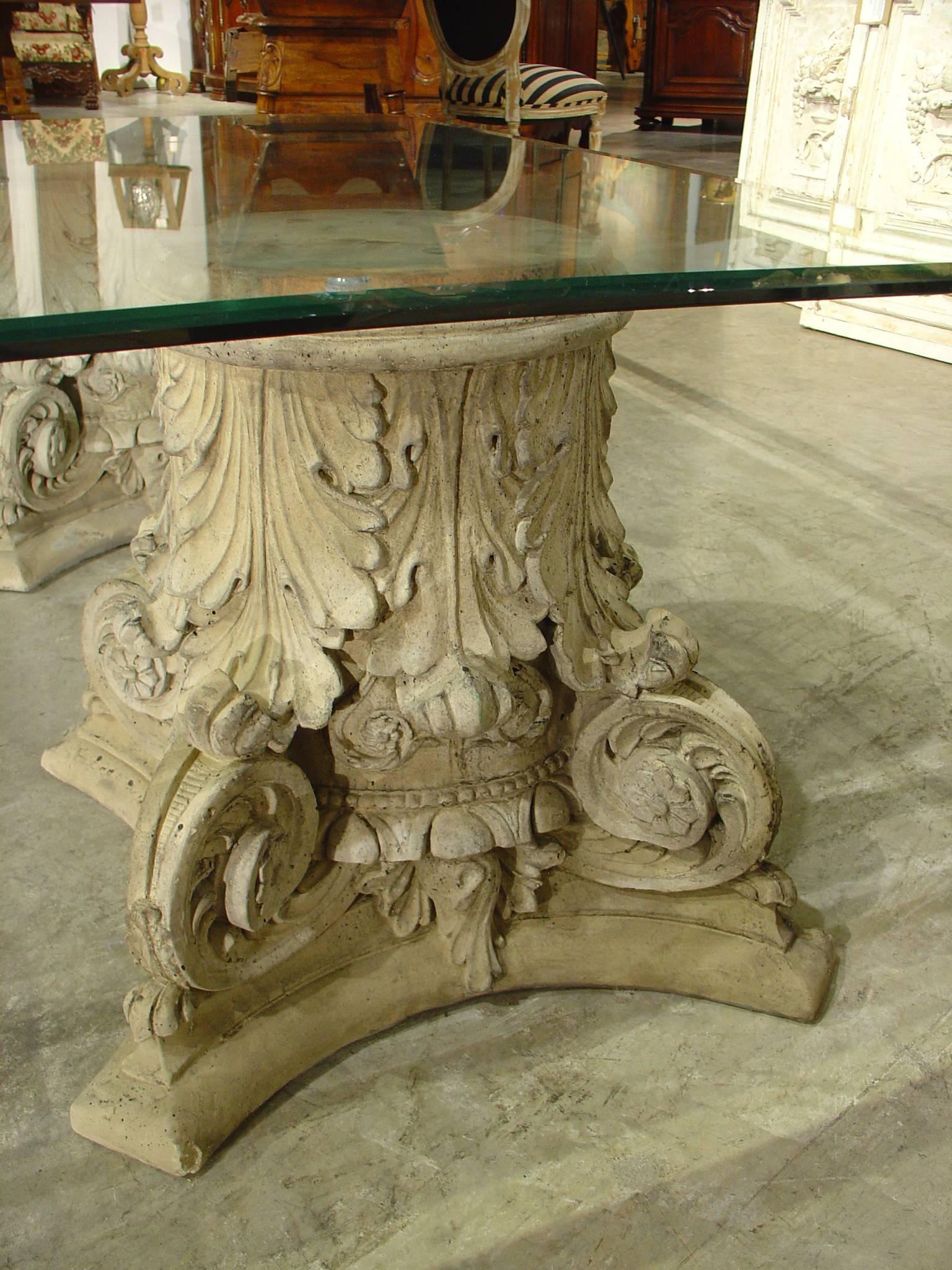 This beautiful and large coffee table is a recent creation of ours. We have added a custom beveled glass to four capital bases. These capital bases are cast from a mixture of crushed stones and cement and the antique coloring is mixed in, so it will
