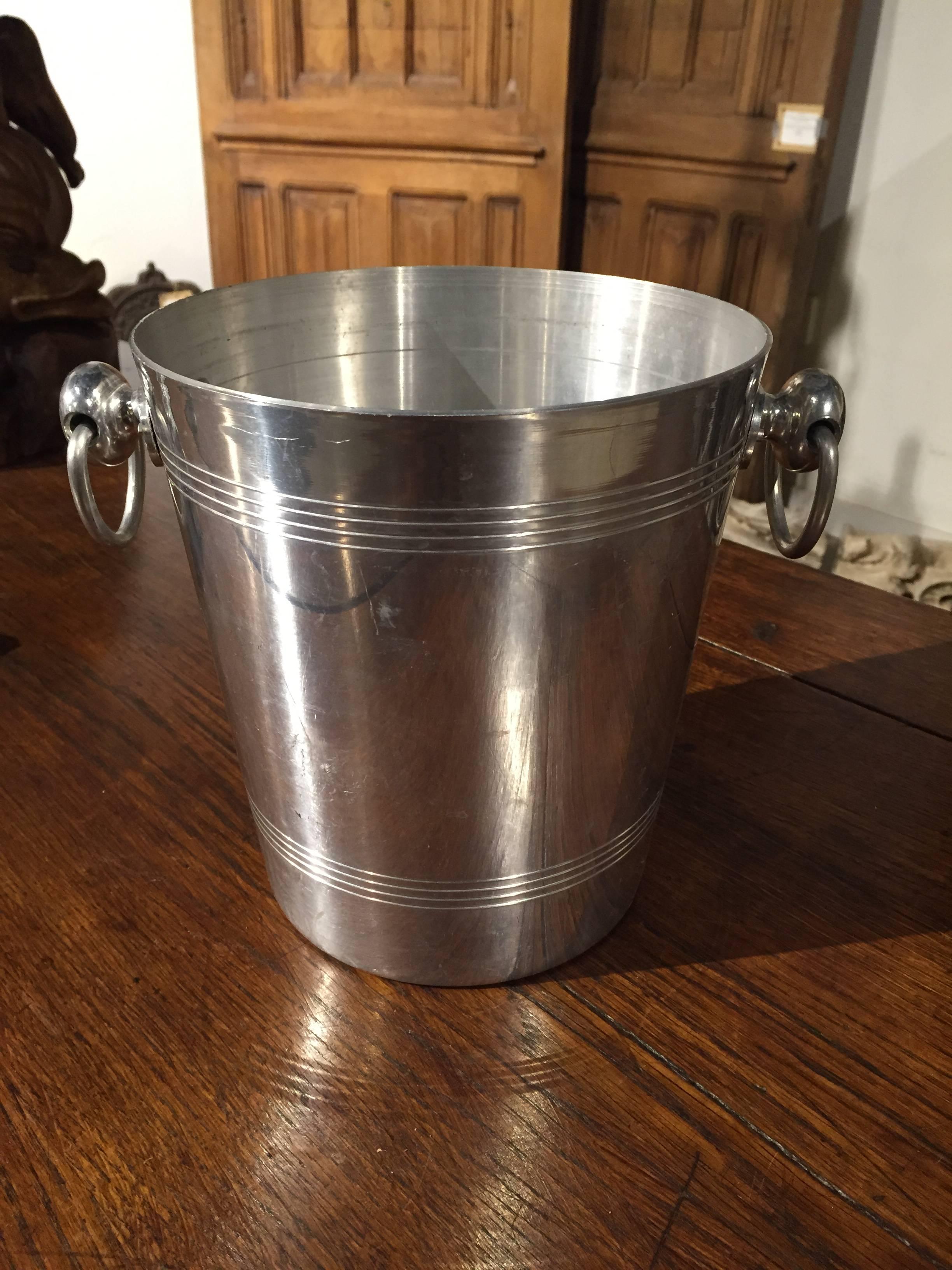 This wonderful champagne bucket has the prestigious Laurent-Perrier Brut L.P. label on the front.  Laurent-Perrier Champagne was founded in 1812 and is recognized as one of the great champagne houses.  Stamped by maker on bottom, and handles make it