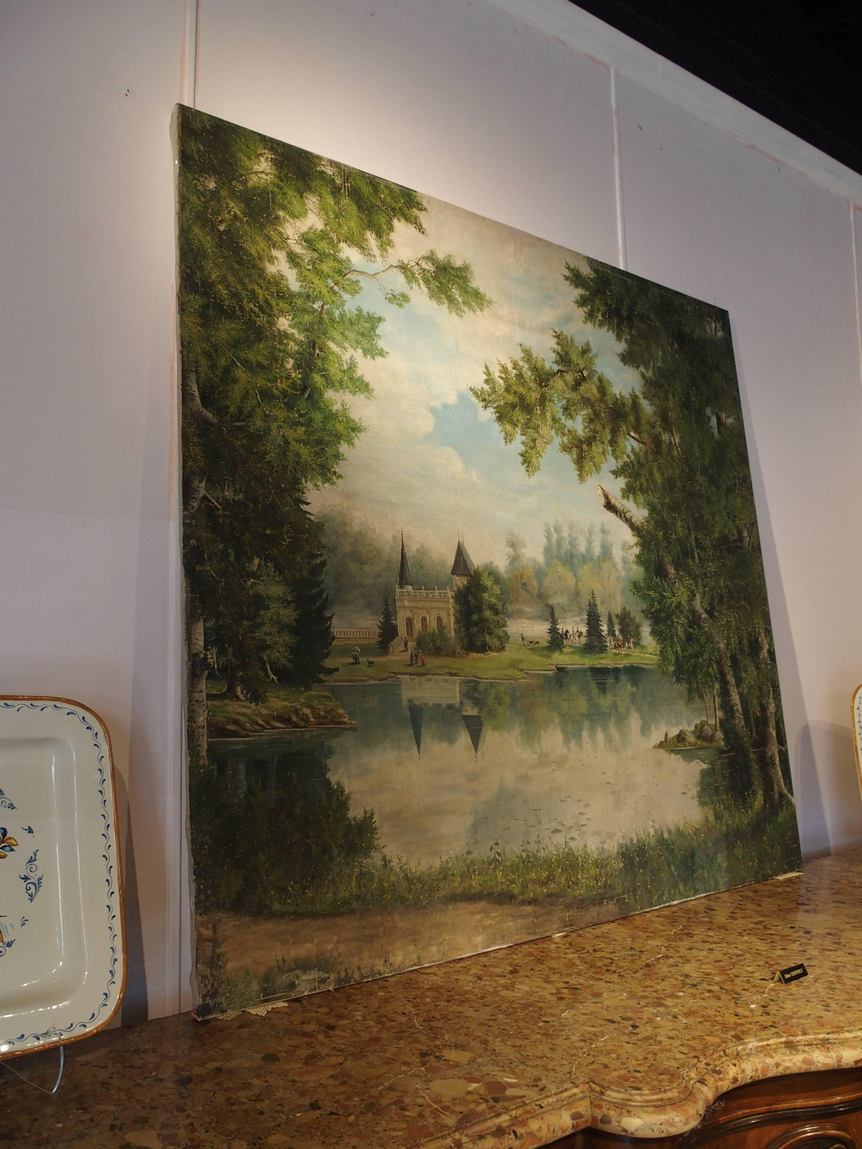 This large and impressive painting on canvas depicts a beautiful stone chateau on a lake in a forested setting. The chateau has beautifully arched doors and windows with a gallery and turrets at the roof line. A stone balustrade fence is to the left