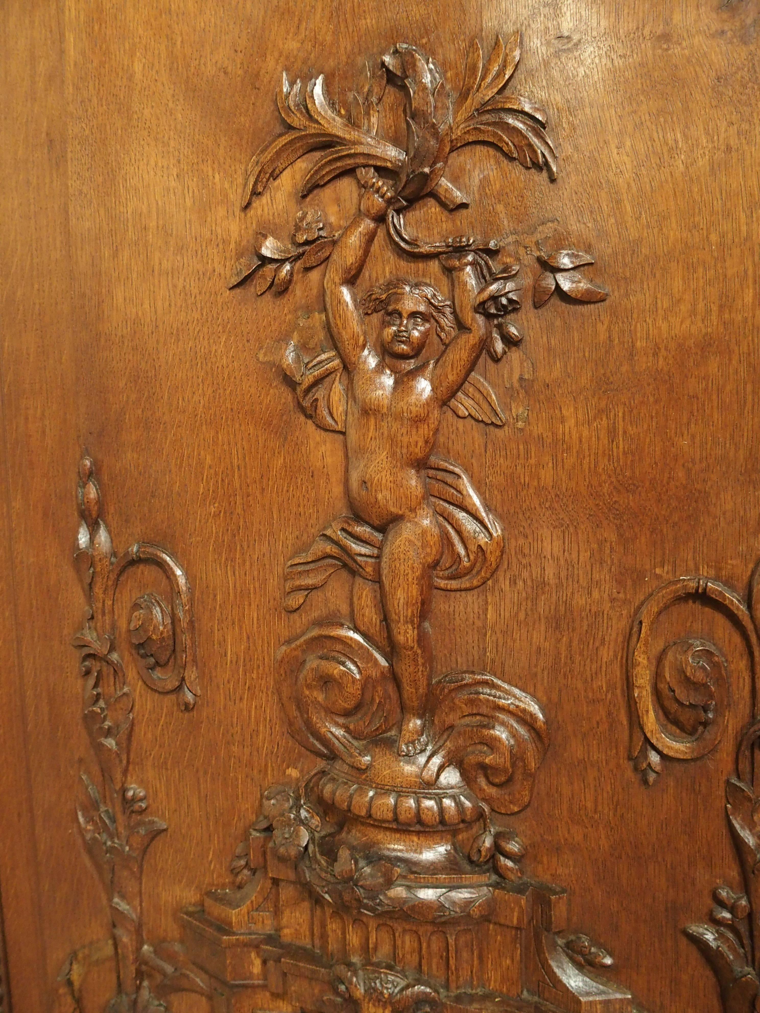 These stunning 19th century French wooden panels came from a boiserie or wooden paneled room. They were most recently salvaged from a chateau north of Paris, and are constructed of French oak. All 3 panels have motifs of musical trophies at the top
