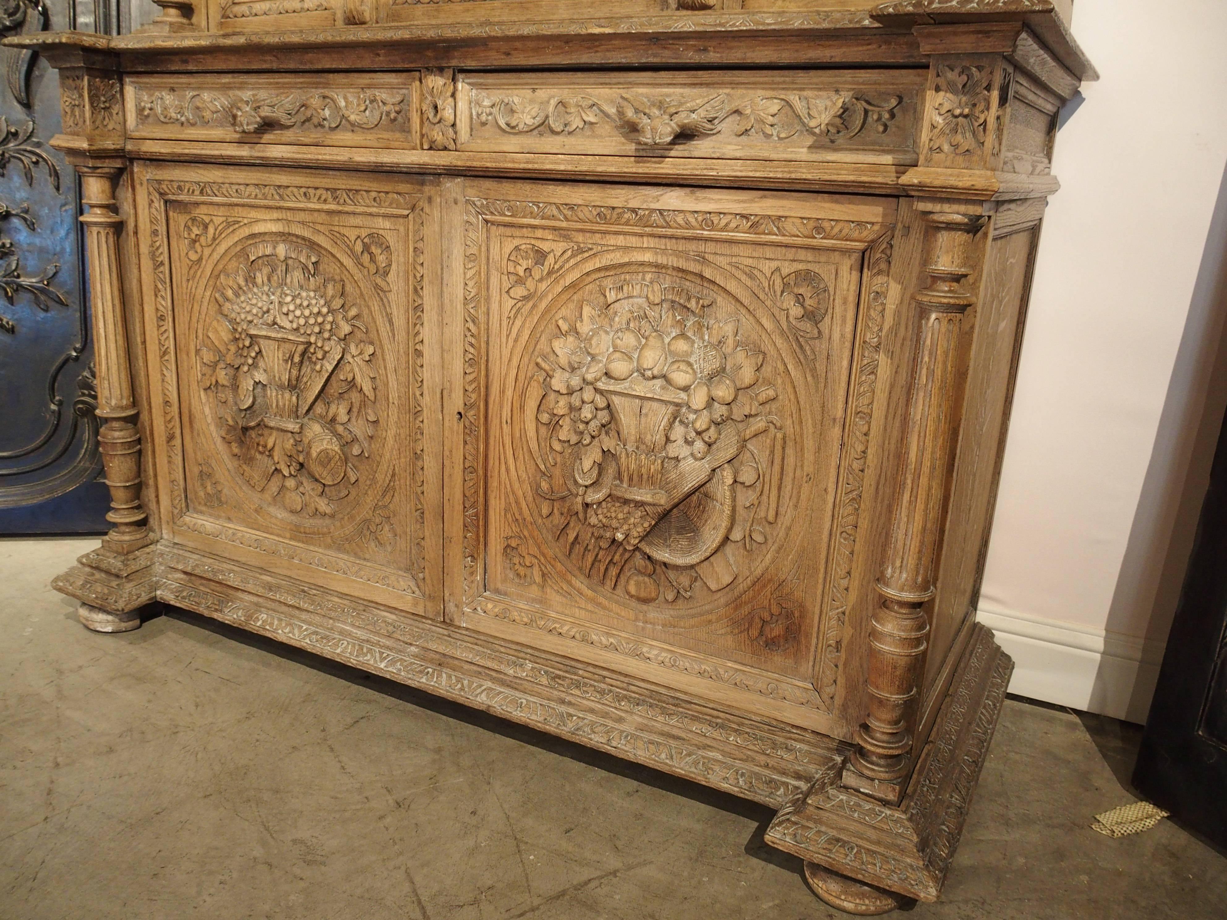 This deux corps has been stripped at some point in its history. This style of deux corps (two bodies or parts) has a narrower depth on the upper part than the lower part, with two drawers between. It has ornamentation in the style of Louis XIII,