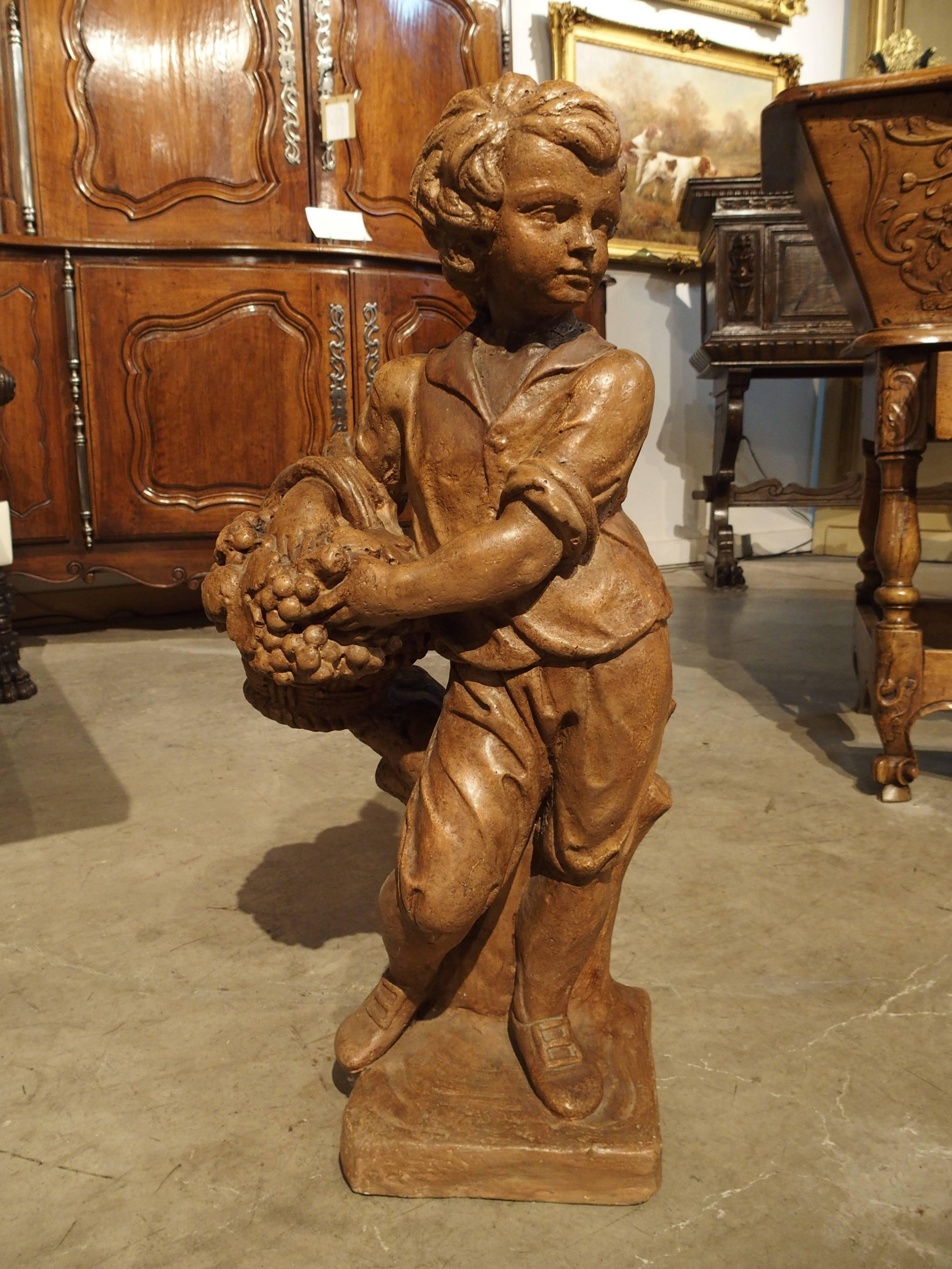 Cast Stone French Vintage Painted Cast Statue of a Boy Holding a Basket of Fruit