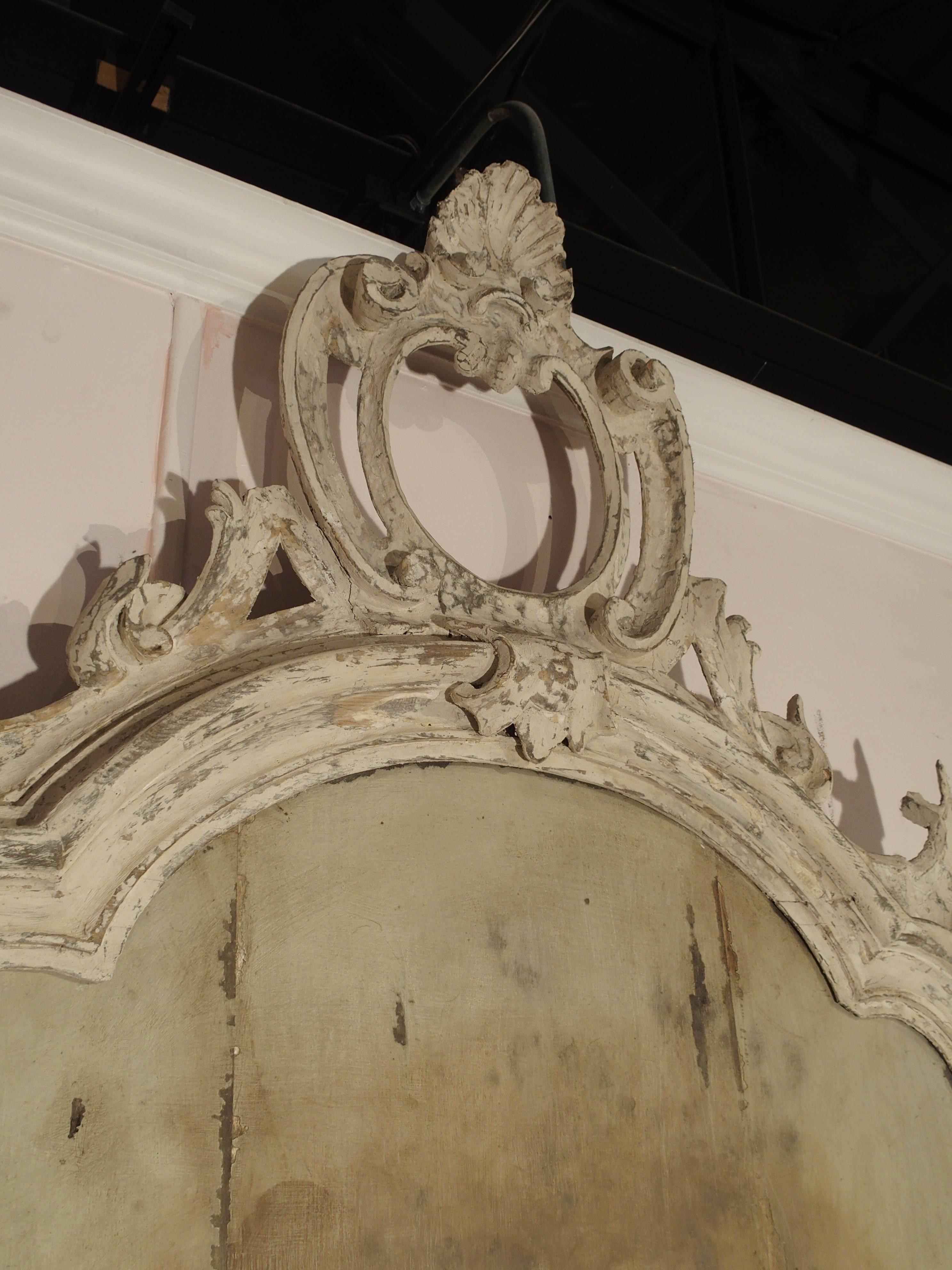 This antique Italian mirror frame is circa 1800. The glass now long gone, has been replaced by a painted scene of The Chateau Cos D'Estournel. The paint has been applied directly to the vertical back boards. The parcel paint frame is stunning with