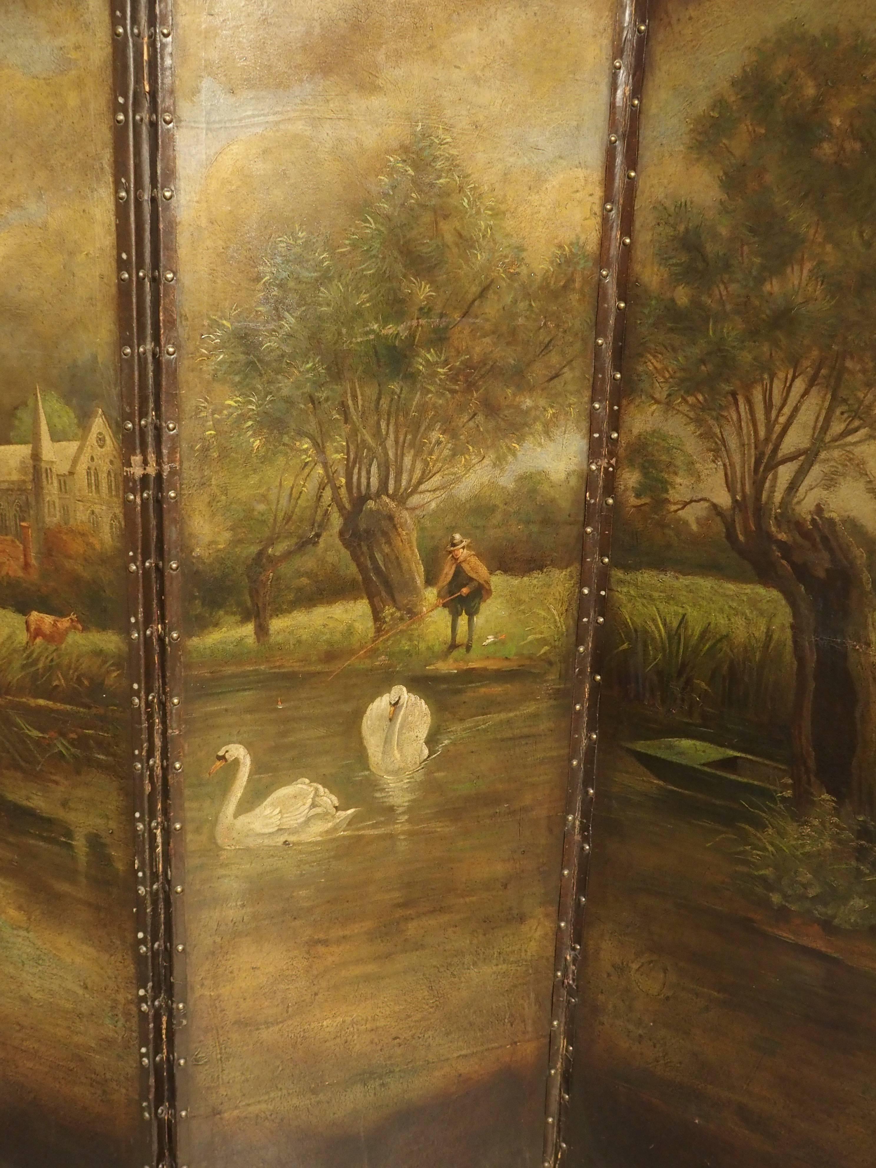 Northern France, circa 1850.

This peaceful French landscape painting has been done in oil on leather on a four panel screen or paravent. Each panel has been hinged together and framed with leather straps using brass nail heads. This beautifully