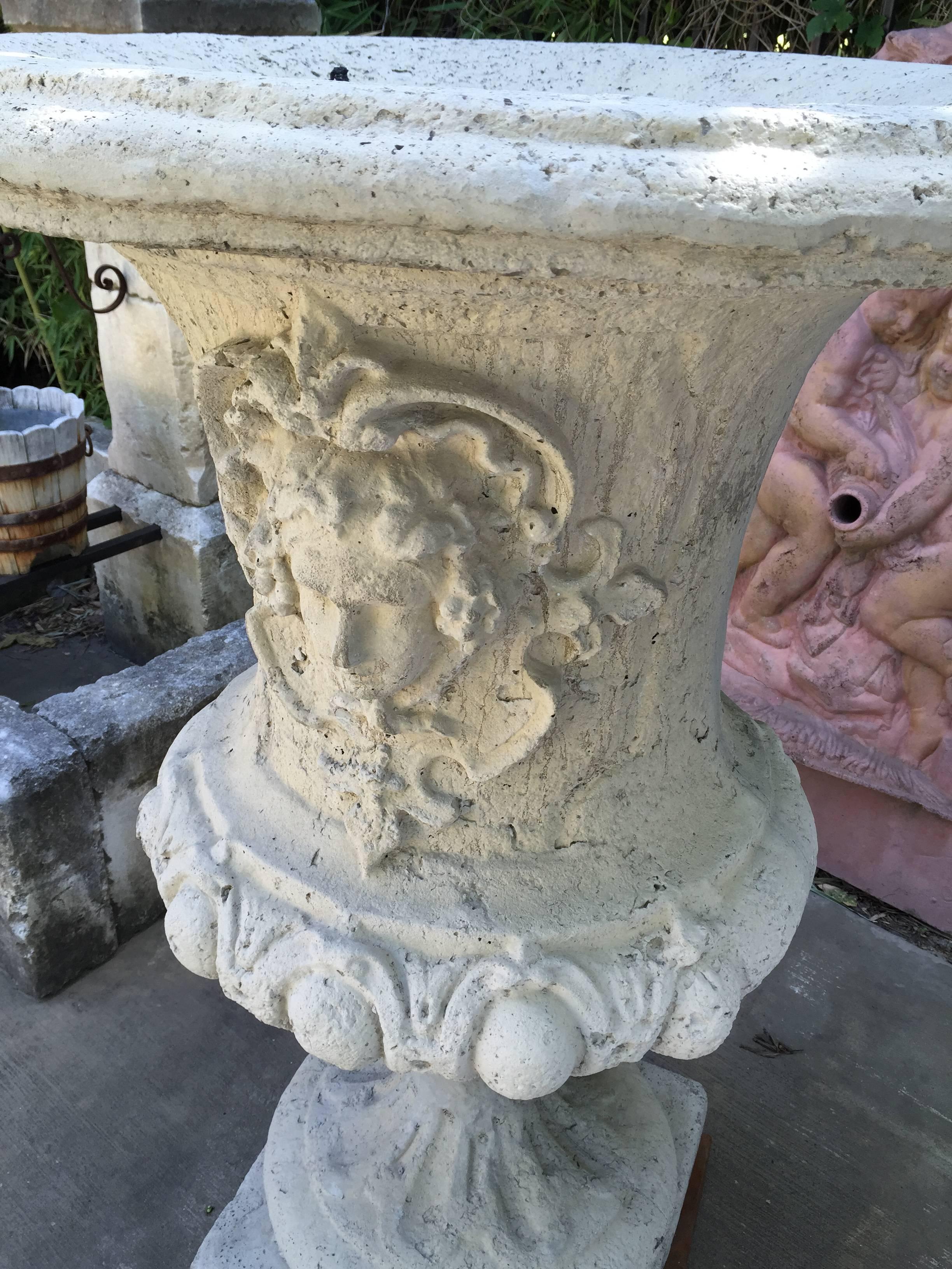 This an imposing pair of 51 inch tall reconstituted stone urns from France. The are cast using a combination of limestone, bluestone and cement. The footprint is 181/2 inches square and the overall design is very elegant and in the style of Louis