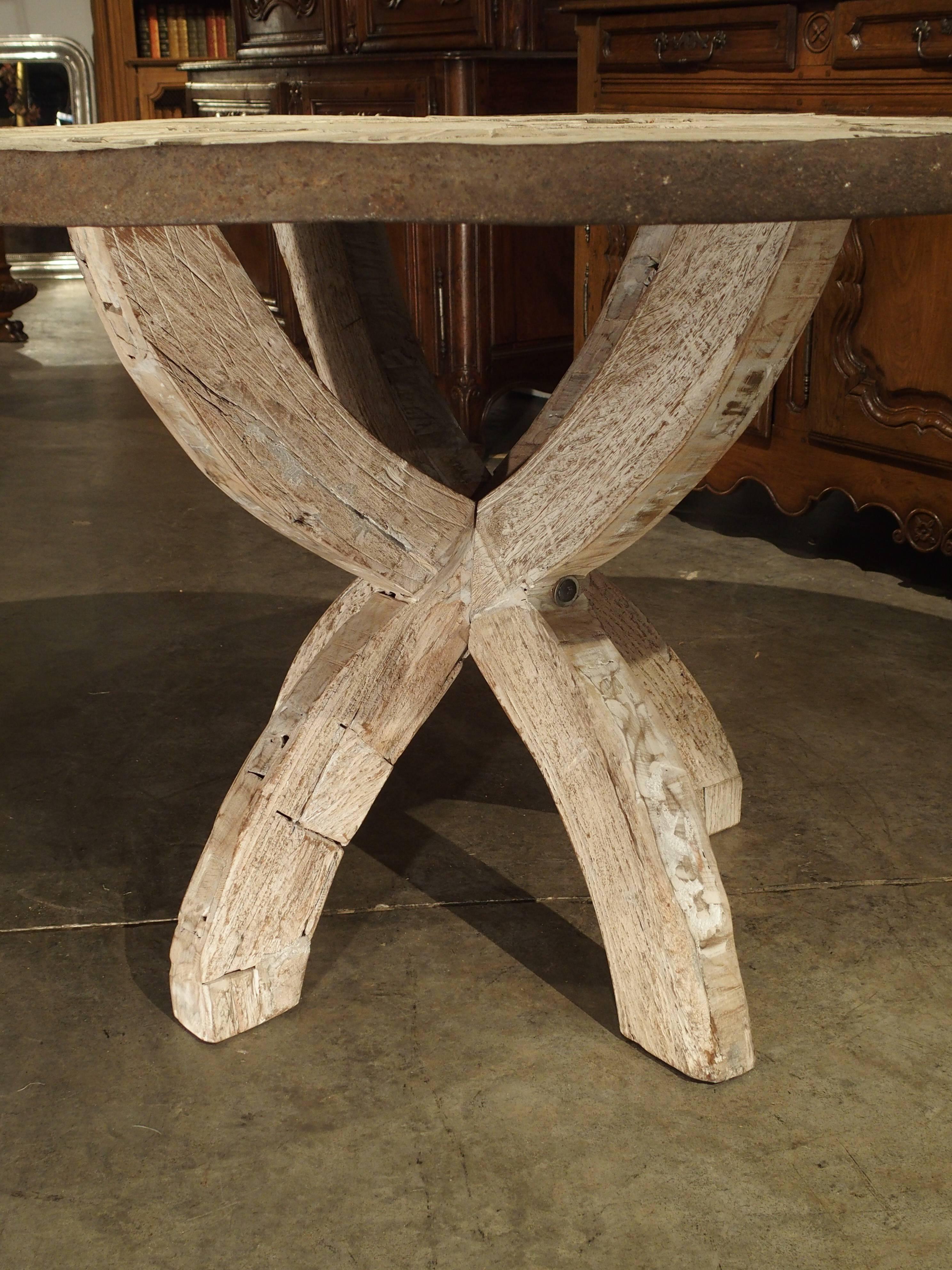 Recent construction, old wood.

This unusual and charming round French table with an iron rimmed top is perfect for a more rustic environment. The wood on the top has been made into three separate circles around a centre round section. The circles