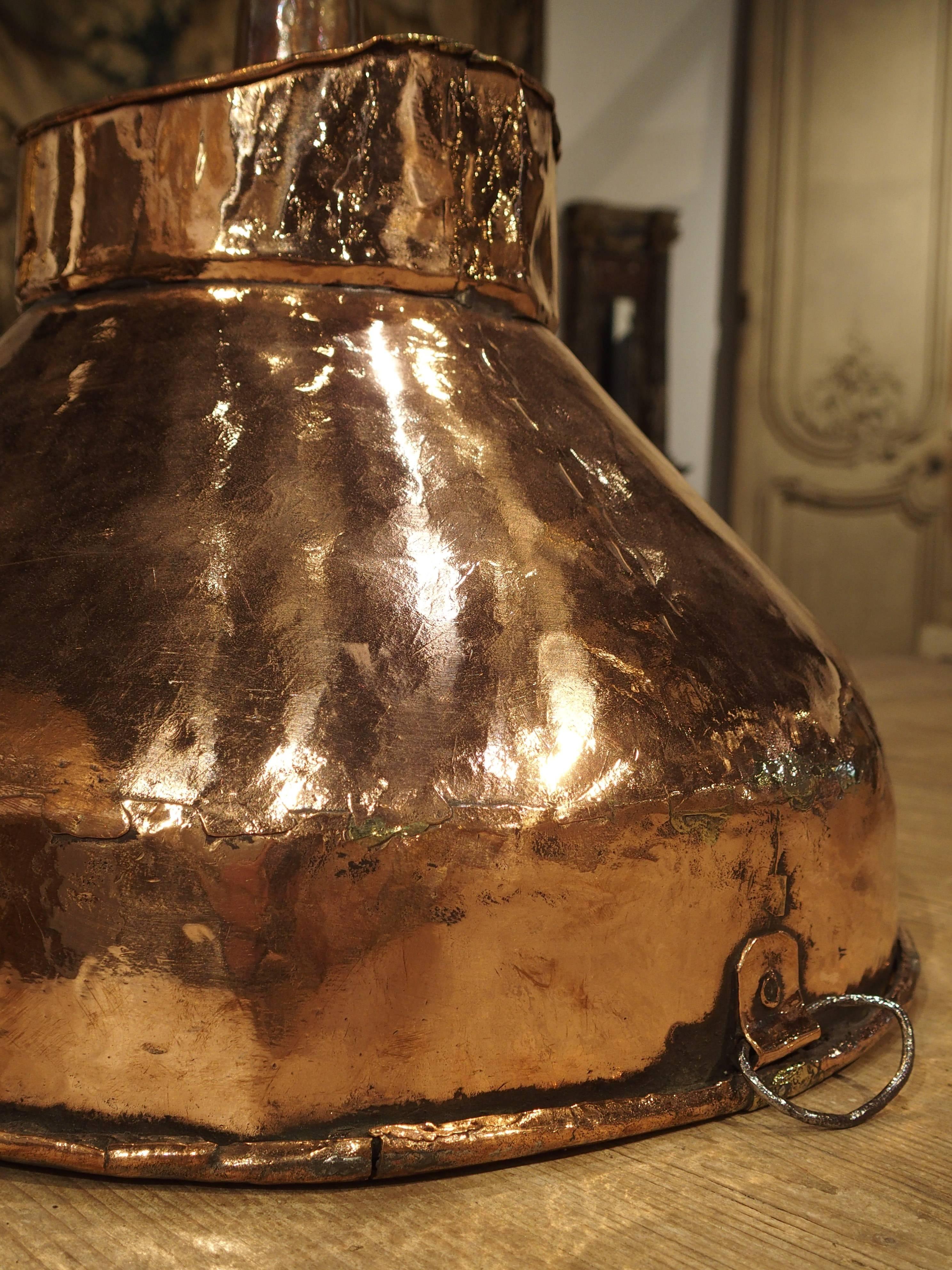 This wonderful old copper funnel dates to the 1700s and is entirely handmade with rolled edges and hammering techniques. It was most likely used to fill larger, Demi-John containers. It would be wonderful as a pendant light or decorative accessory.