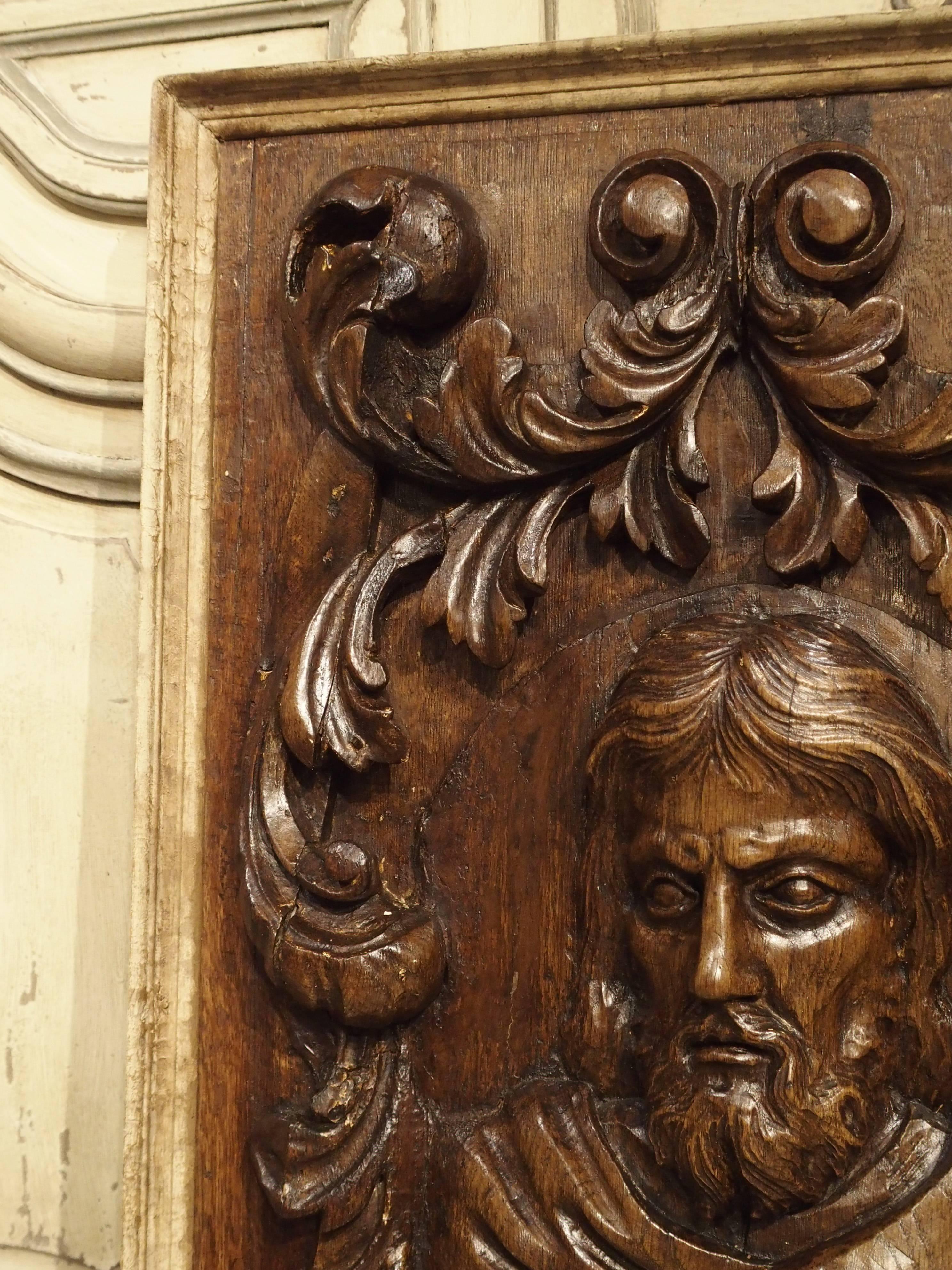This hand-carved wooden relief is of St. Mark and the winged lion, the symbol of Venice. The plaque dates to the 1700s. The hand carving is deep and in proportion, obviously done by a master carver. The motifs surrounding St. Mark are C-scroll