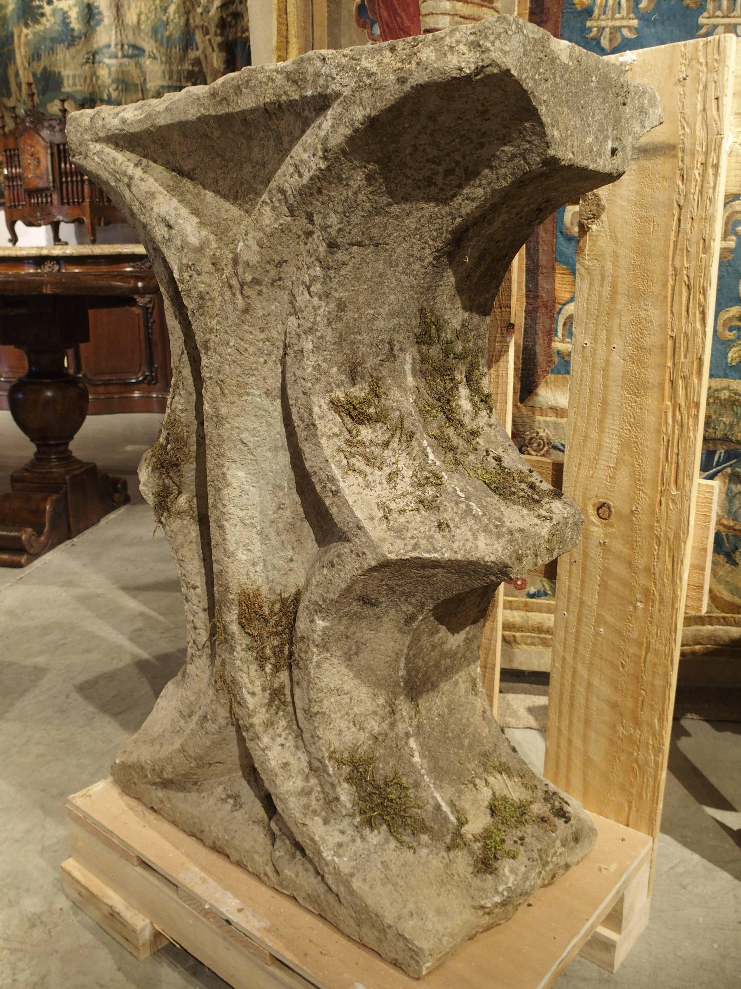 This fabulous French Gothic architectural fragment dates to the 1400s. It was possibly the interior section between two, partial C-scrolls and cusps of a circular Gothic cinquefoil. As a rare and extremely old fragment, it can be displayed as a