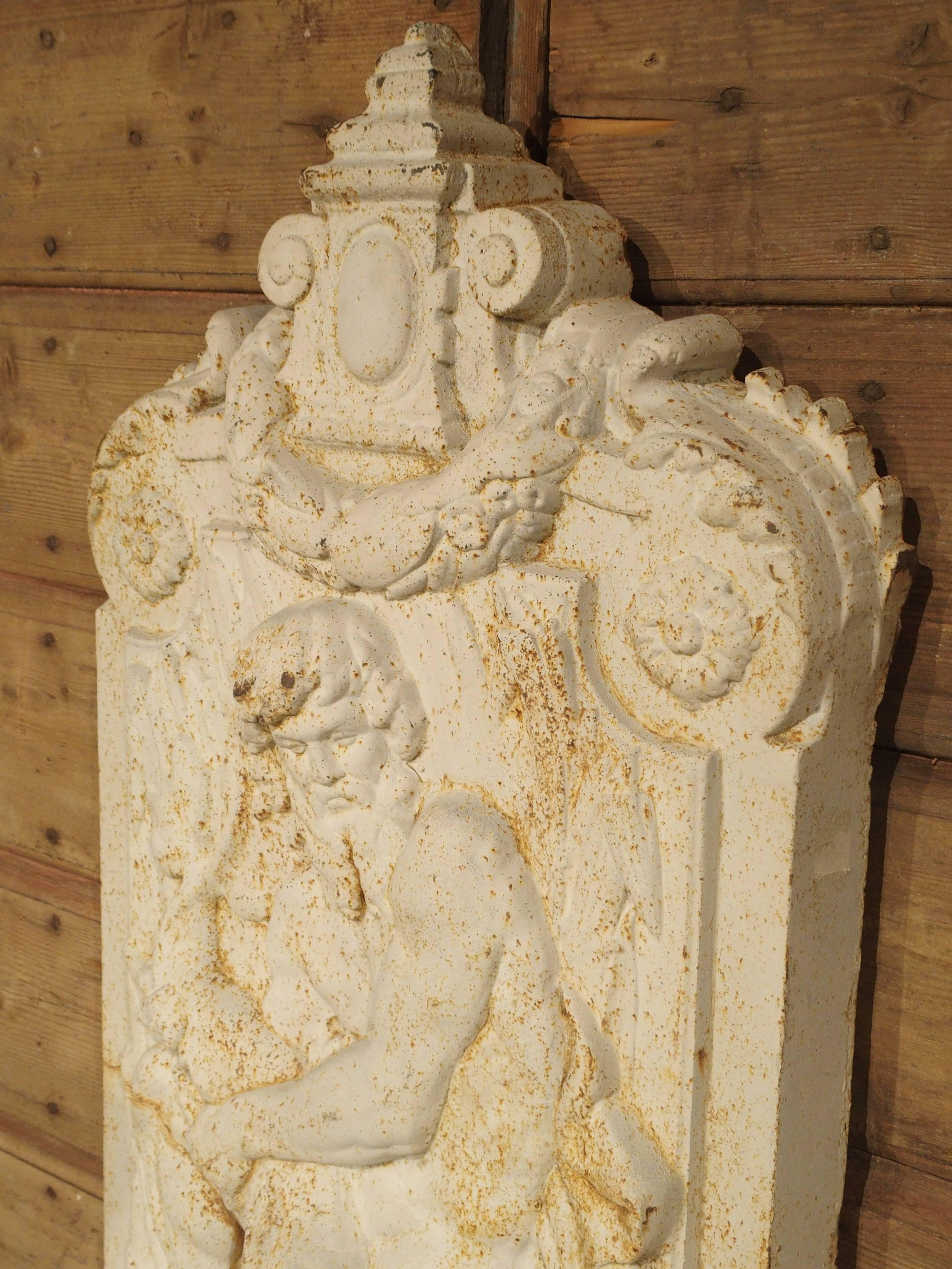 This painted cast iron fountain is typical of the street fountains that were located in and around Paris starting in the second half of the 1800s, during a period of heavy construction. It is based on the original design by the famous Val D'Osne