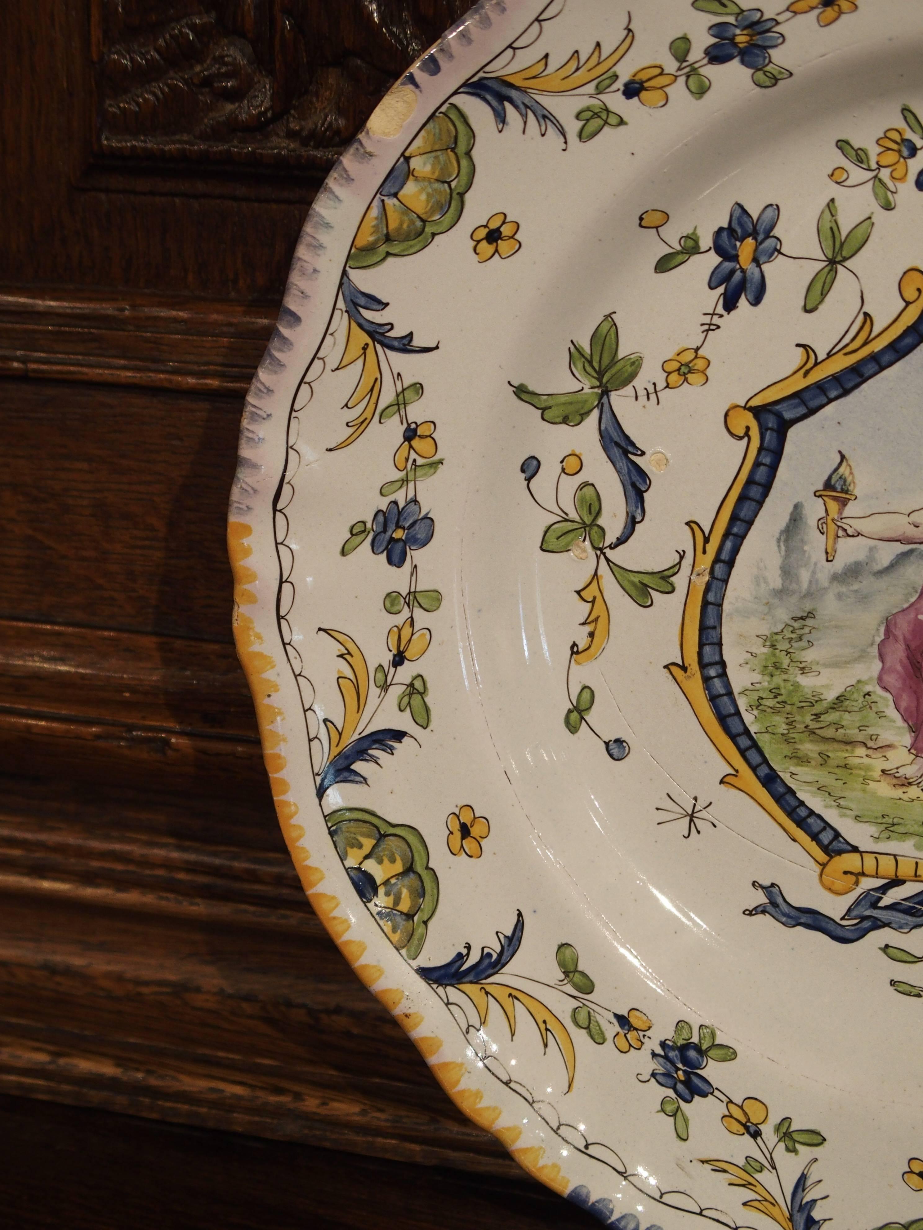 This reproduction French plate is after an antique French Faience plate. It is marked EF to the back, completely handmade and painted and is very decorative. These plates were used in vaisseliers, vitrines and display cabinets.